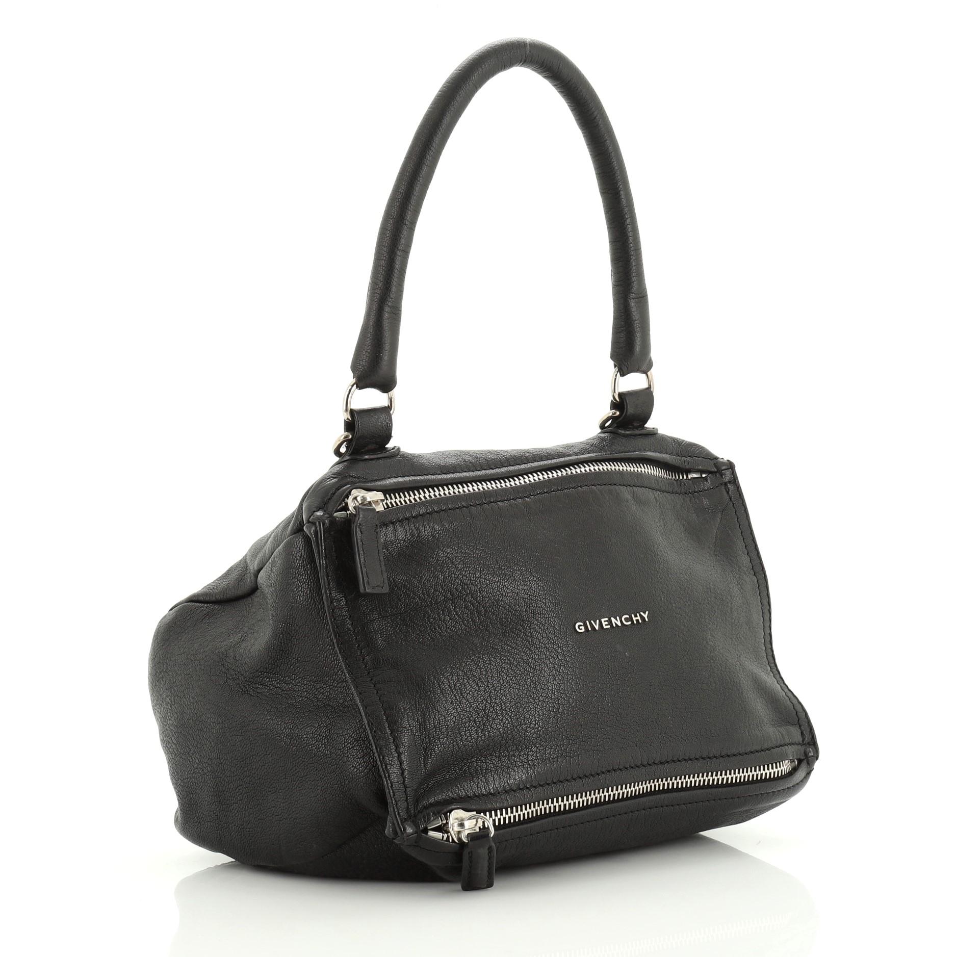 This Givenchy Pandora Bag Leather Small, crafted from black leather, features a rolled top handle, Givenchy logo at the center, and silver-tone hardware. Its two-way zip fastenings open to a black fabric interior with side zip and slip pockets.