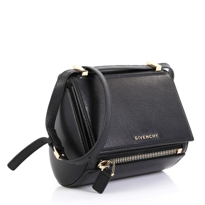 This Givenchy Pandora Box Bag Leather Mini, crafted from black leather, features an adjustable leather strap and gold-tone hardware. Its push-lock closure opens to a black microfiber interior with side zip pocket. 

Estimated Retail Price: