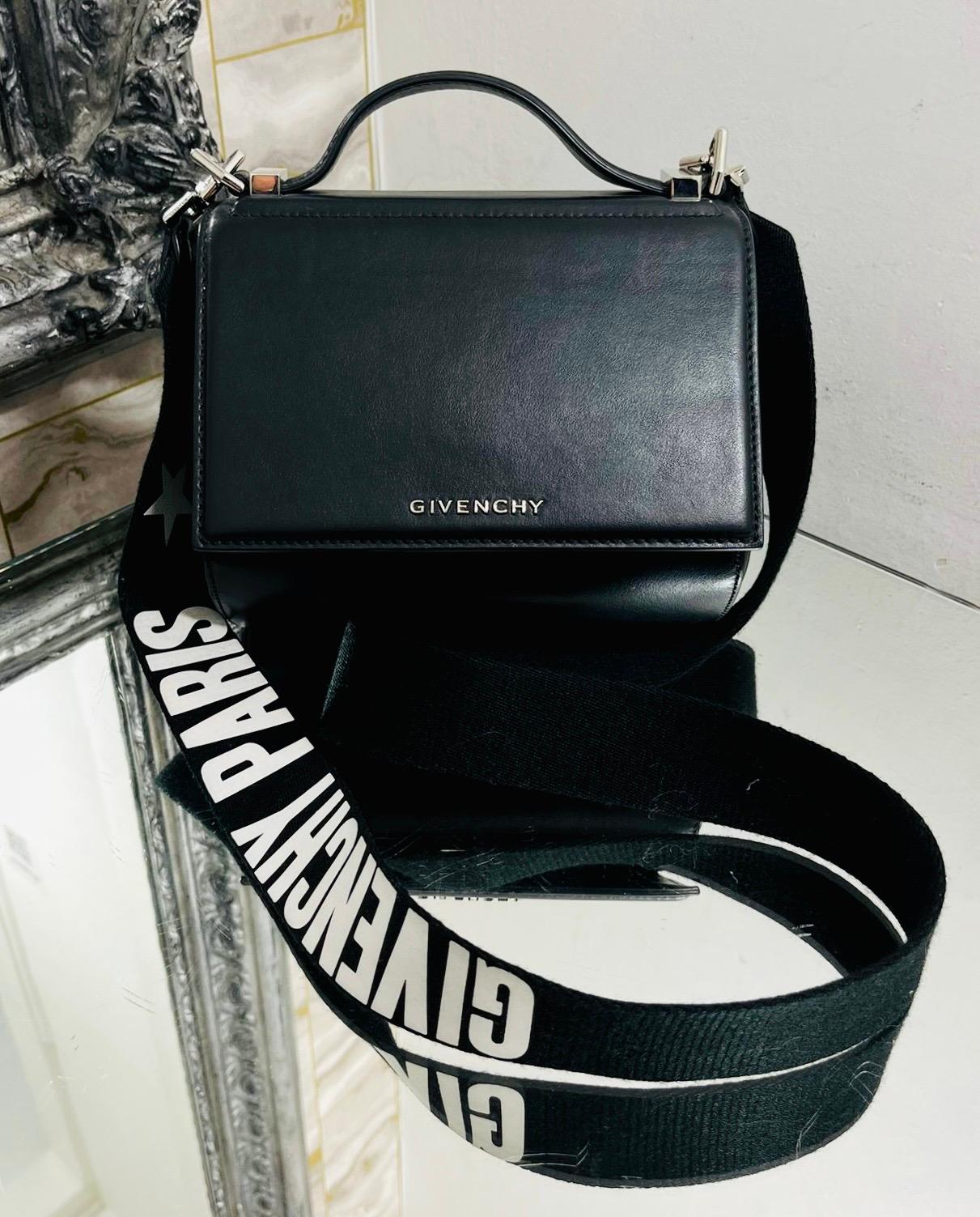 Givenchy Pandora Box Logo Leather Bag

Boxy messenger bag designed with front flap clasp closure and detailed with silver 'Givenchy' logo lettering.

Featuring black canvas, wide detachable shoulder strap styled with 'Givenchy Paris' inscription in