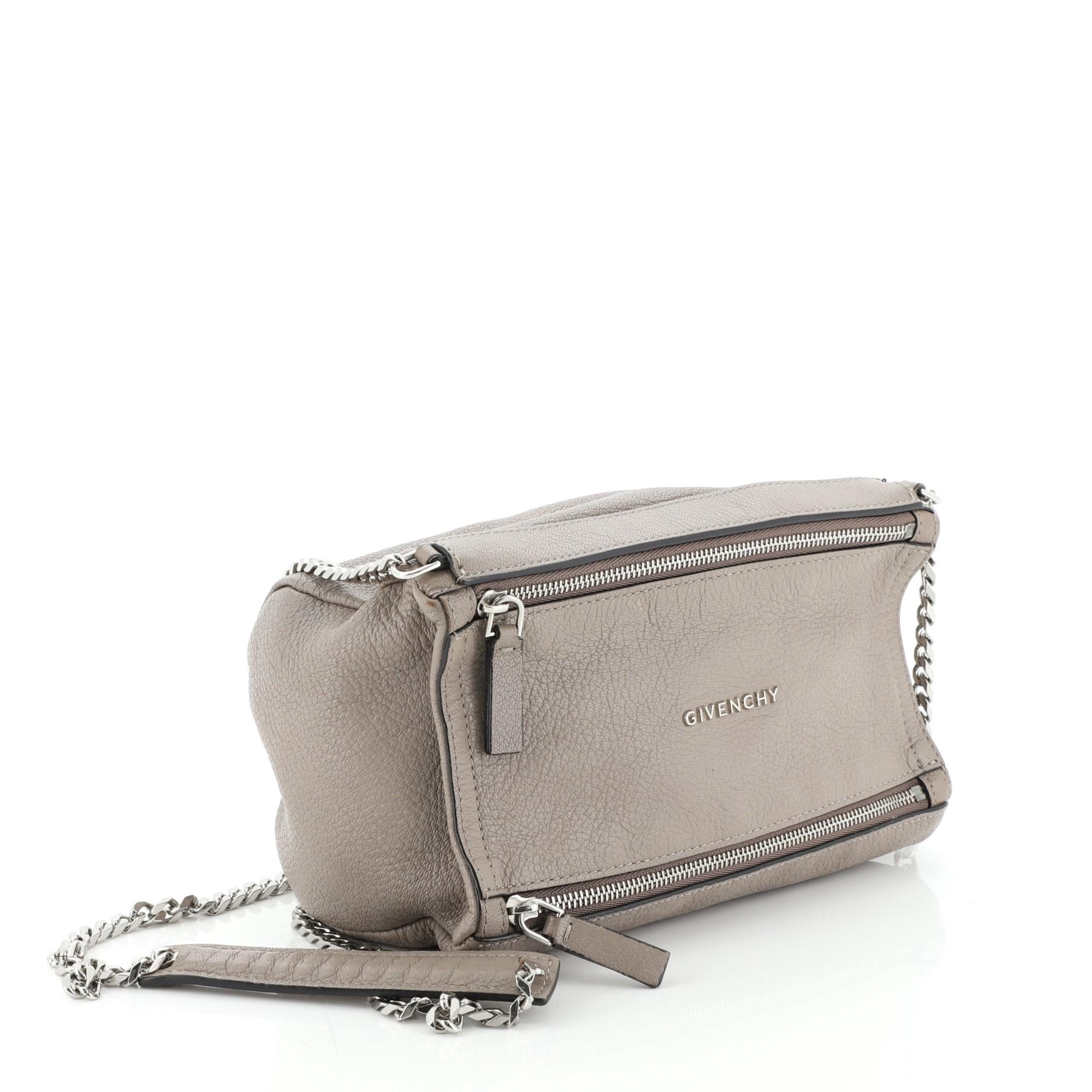 This Givenchy Pandora Chain Bag Leather Mini, crafted from neutral leather, features a chain link shoulder strap, Givenchy logo at the center, and silver-tone hardware. Its double zip fastenings open to a black fabric compartment. 

Estimated Retail