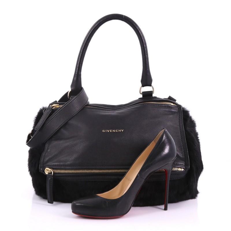 This Givenchy Pandora Handbag Leather and Fur Medium, crafted from black leather and fur, features a single rolled leather handle, front zip compartments, and gold-tone hardware. Its top zip closure opens to a black fabric interior with side zip