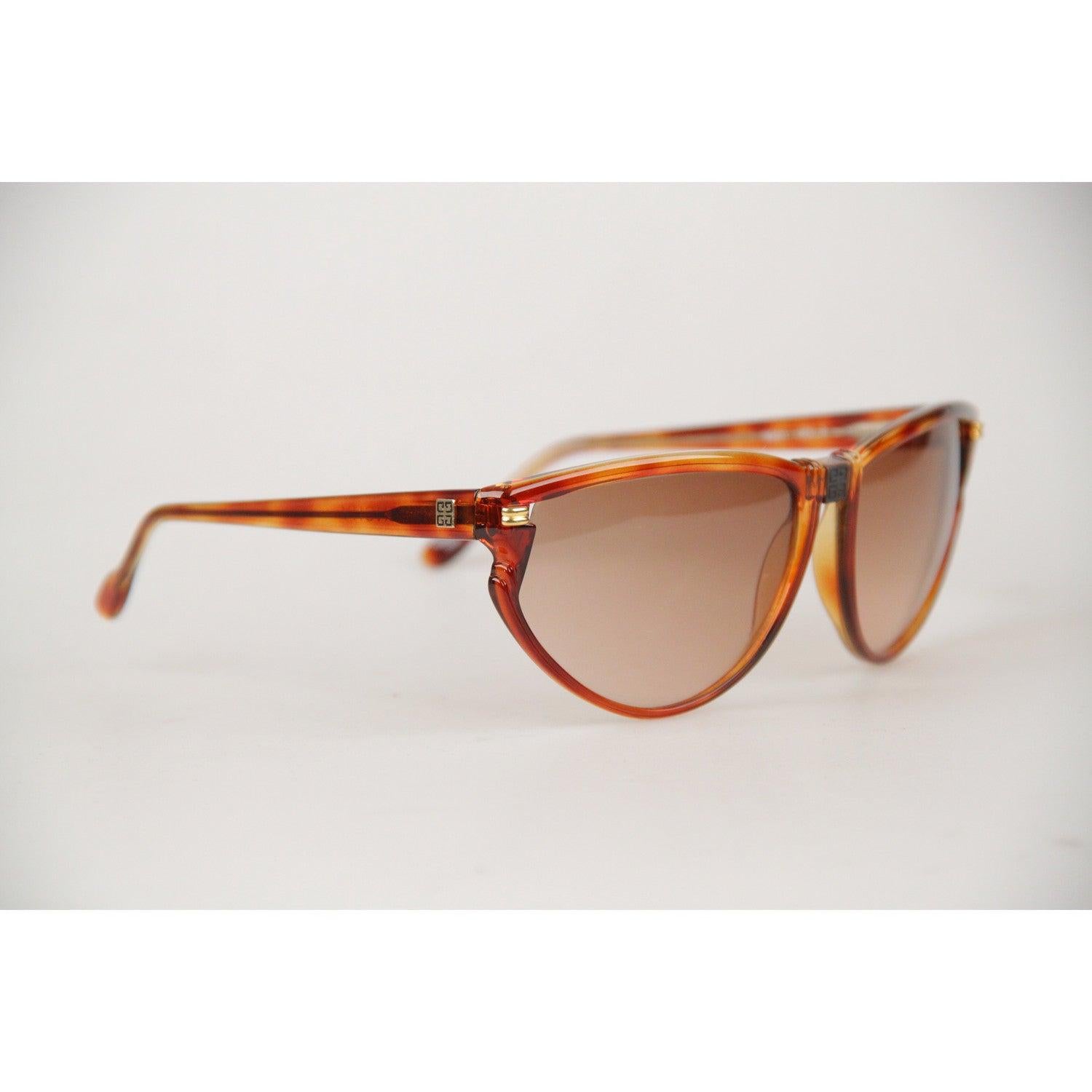 Elegant, original Vintage 1980s Sunglasses by GIVENCHY. Cat-Eye look Tortoise semi-transparent Brown Acetate frame. Gold metal hardware on the sides. Brown Gradient. 100% UV protection NEW lens. Frame Hand Made In France. Model Refs: SG01 - COL 02