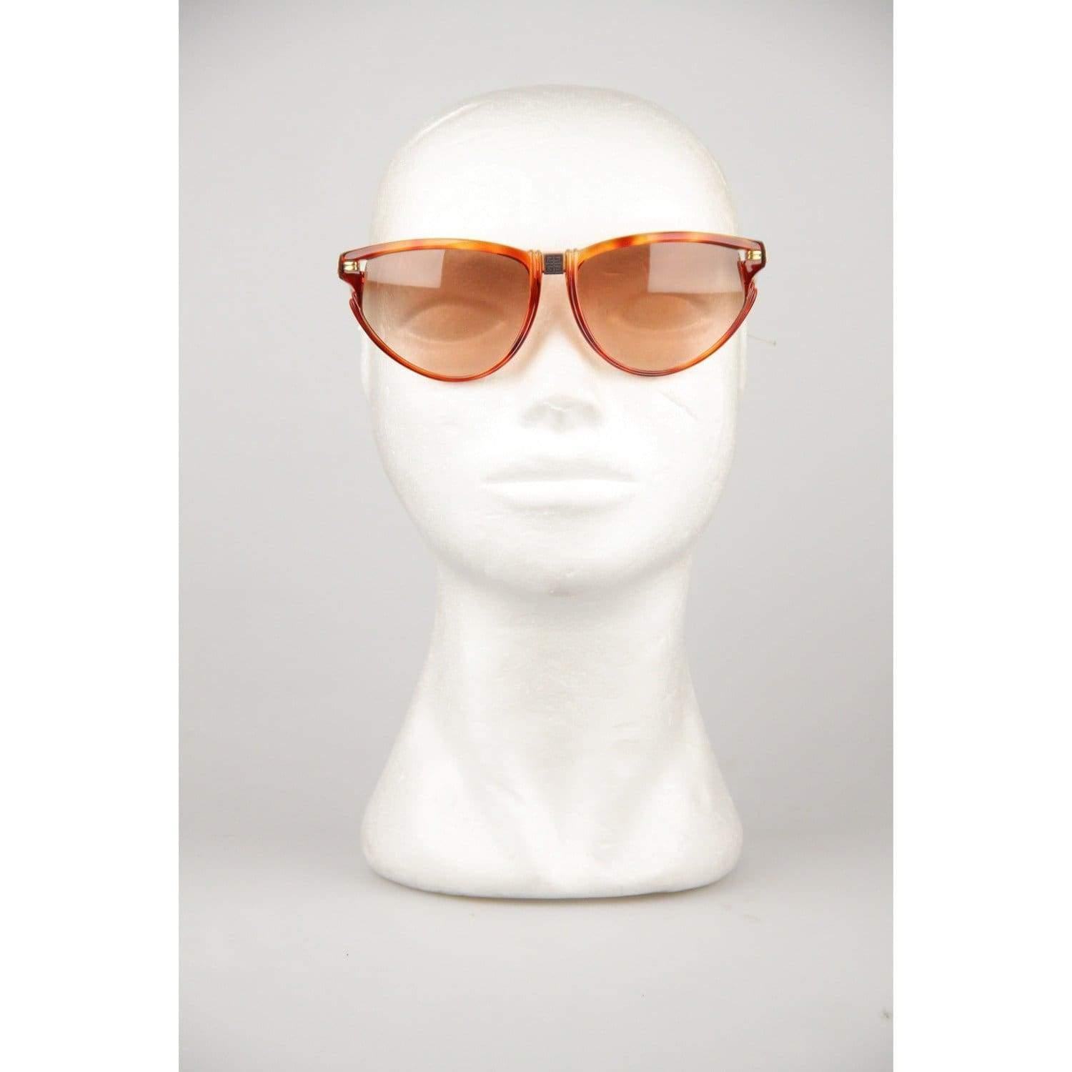Elegant, original Vintage 1980s Sunglasses by GIVENCHY. Cat-Eye look Tortoise semi-transparent Brown Acetate frame. Gold metal hardware on the sides. Brown Gradient. 100% UV protection NEW lens. Frame Hand Made In France. Model Refs: SG01 - COL