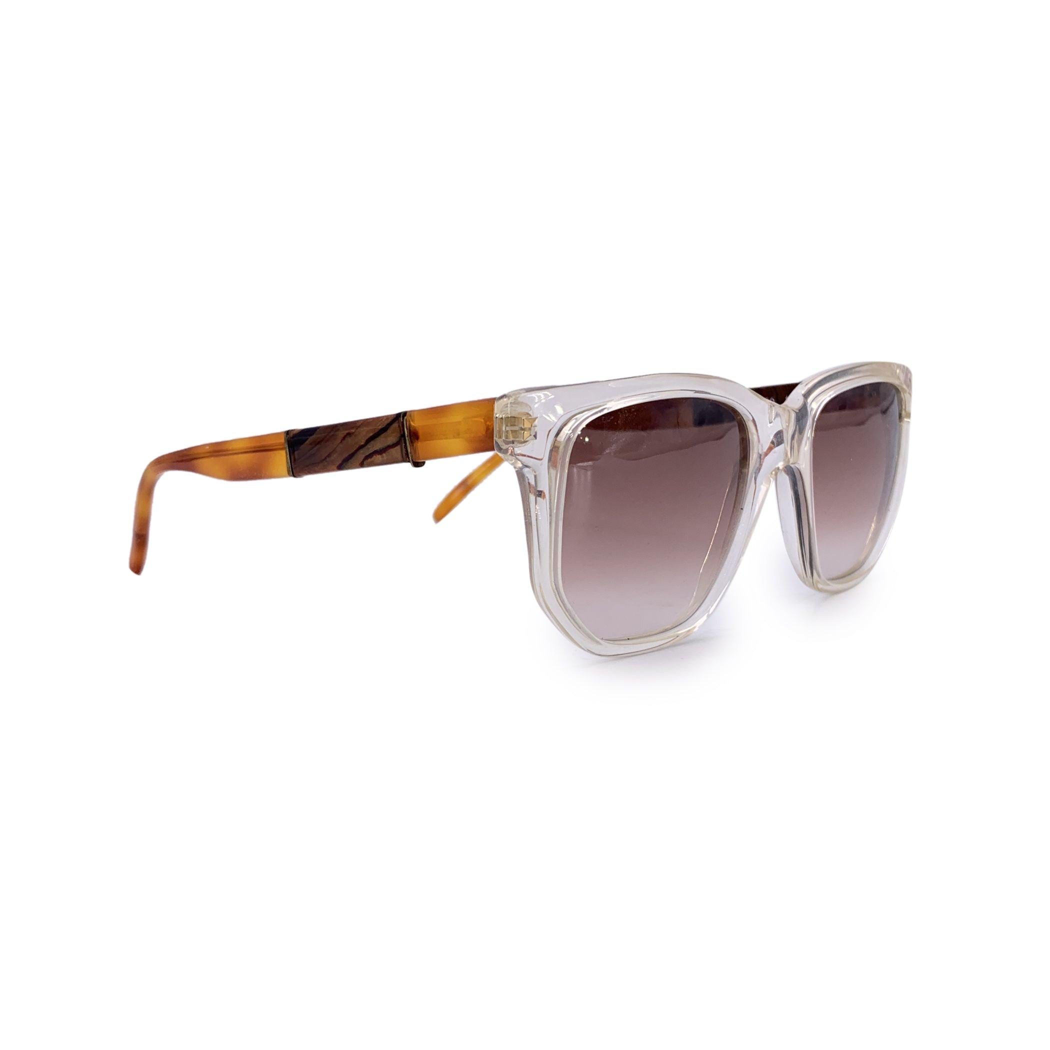 A true gem from the golden age of glamour, these original 1980s Givenchy sunglasses - Model A 02 120 - are the embodiment of vintage elegance with a bold Parisian twist. Featuring a chic squared silhouette, the frame is crafted from clear acetate