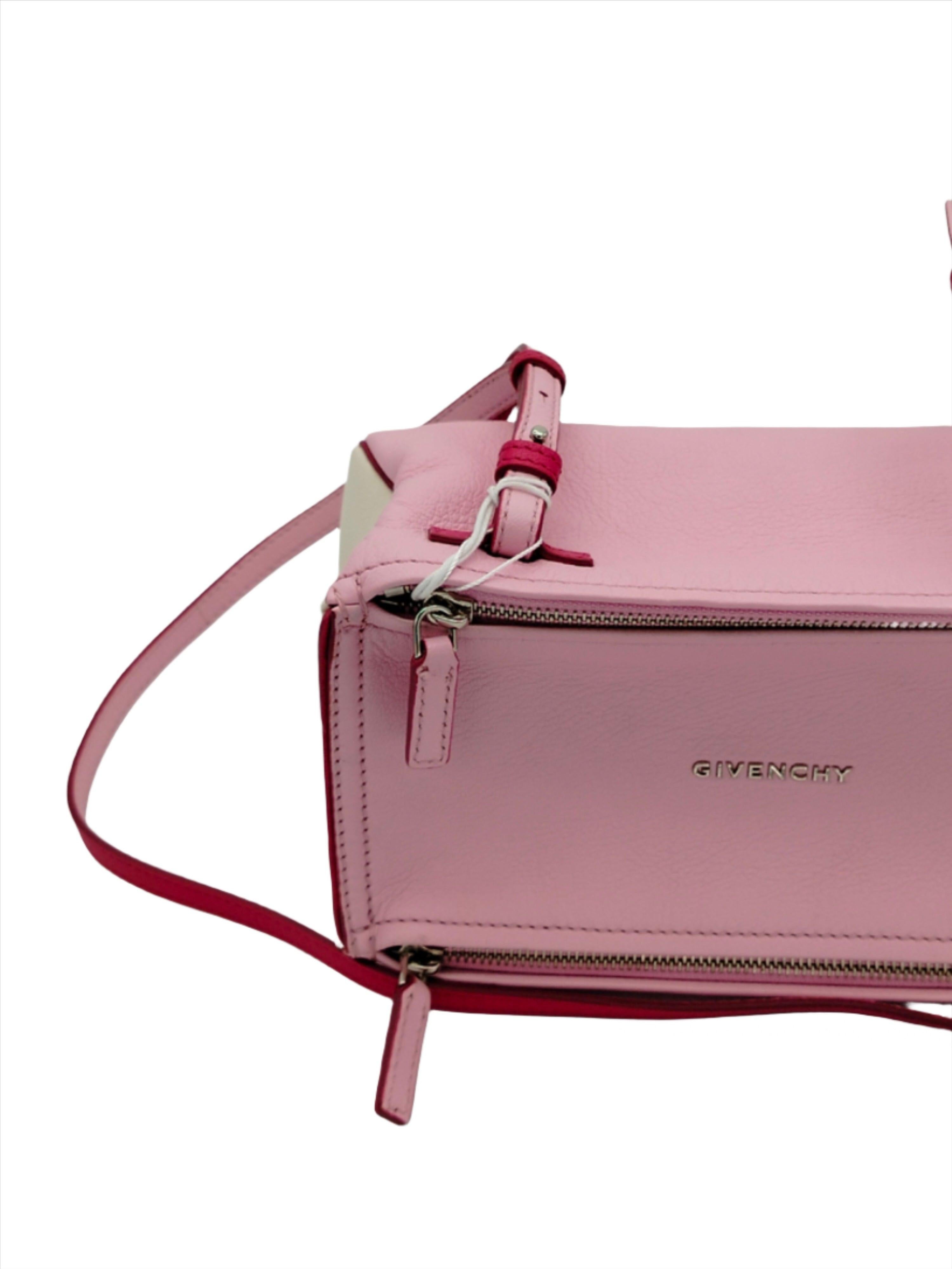 Givenchy clutch bag in Pandora, small, made of pink leather with silver-tone hardware. With two front zippers with metal applications. Adjustable, detachable shoulder strap in matching color leather. The interior is lined in beige suede and is