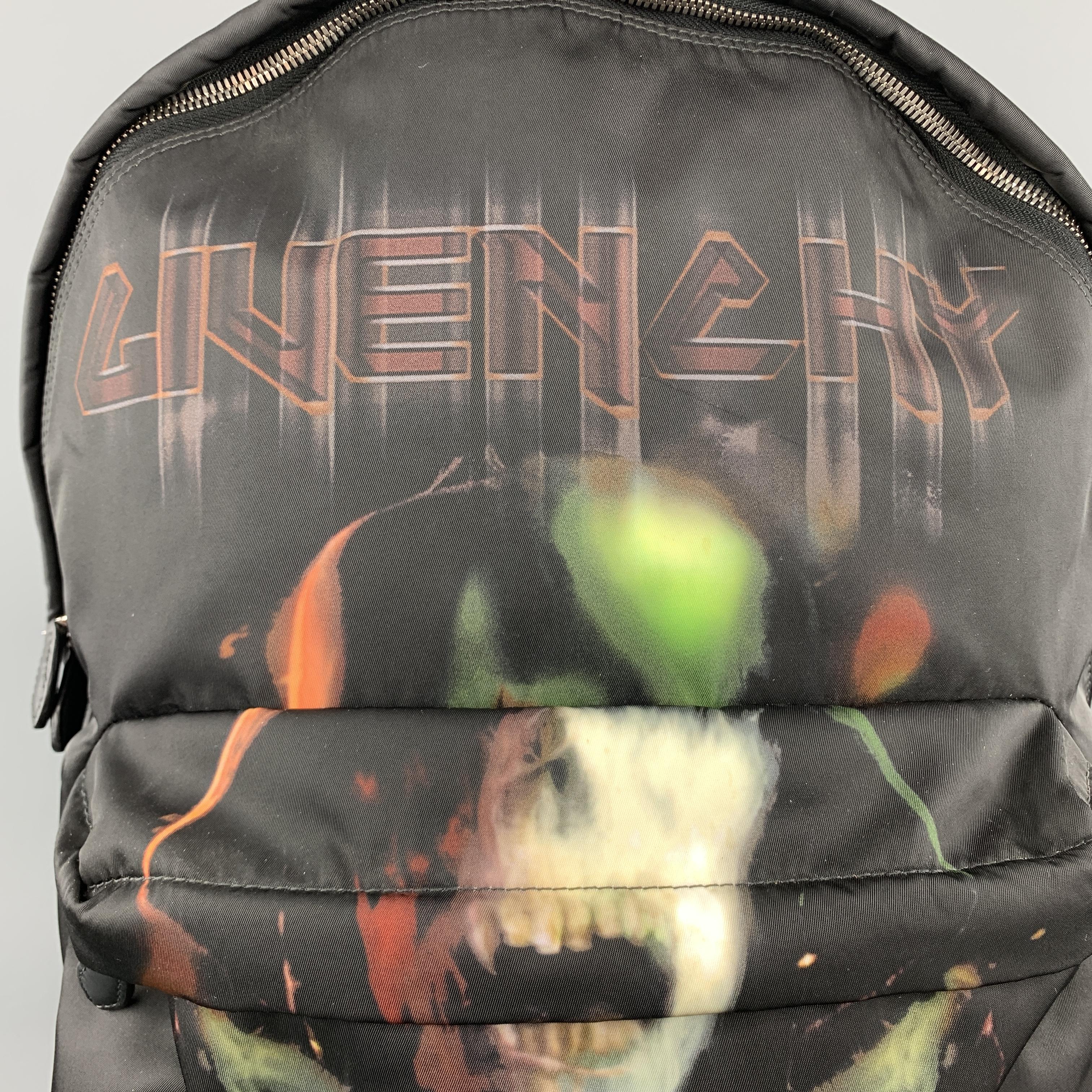 GIVENCHY by RICCARDO TISCI backpack comes in black nylon with leather details, frontal zip pocket, back card holder, and skull crossbones metal logo graphic print motif. 

Excellent Pre-Owned Condition. Retails: $1,350.00.

Measurements:

Length: 14