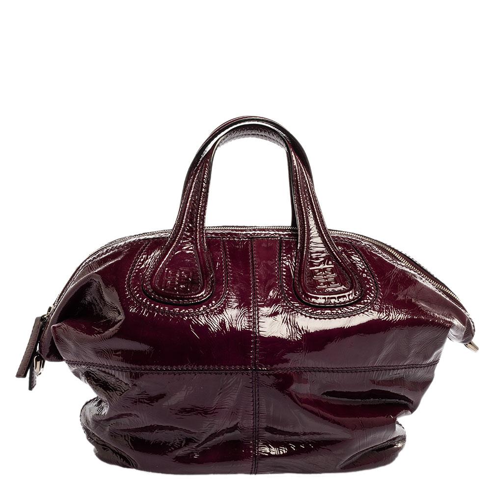 Meticulously crafted from glossy patent leather in a purple hue, this classy Nightingale bag from Givenchy is a creation that is ideal for daily use. It features two top handles, a shoulder strap, and a spacious canvas interior to hold your