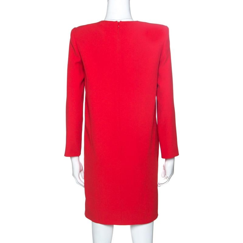 This lovely shift dress from Givenchy is a closet must-have. Crafted from quality materials, it is lined with 100% silk. This luxurious garment is made striking with a bright red color. It is styled with padded shoulders, a round neck, long sleeves,