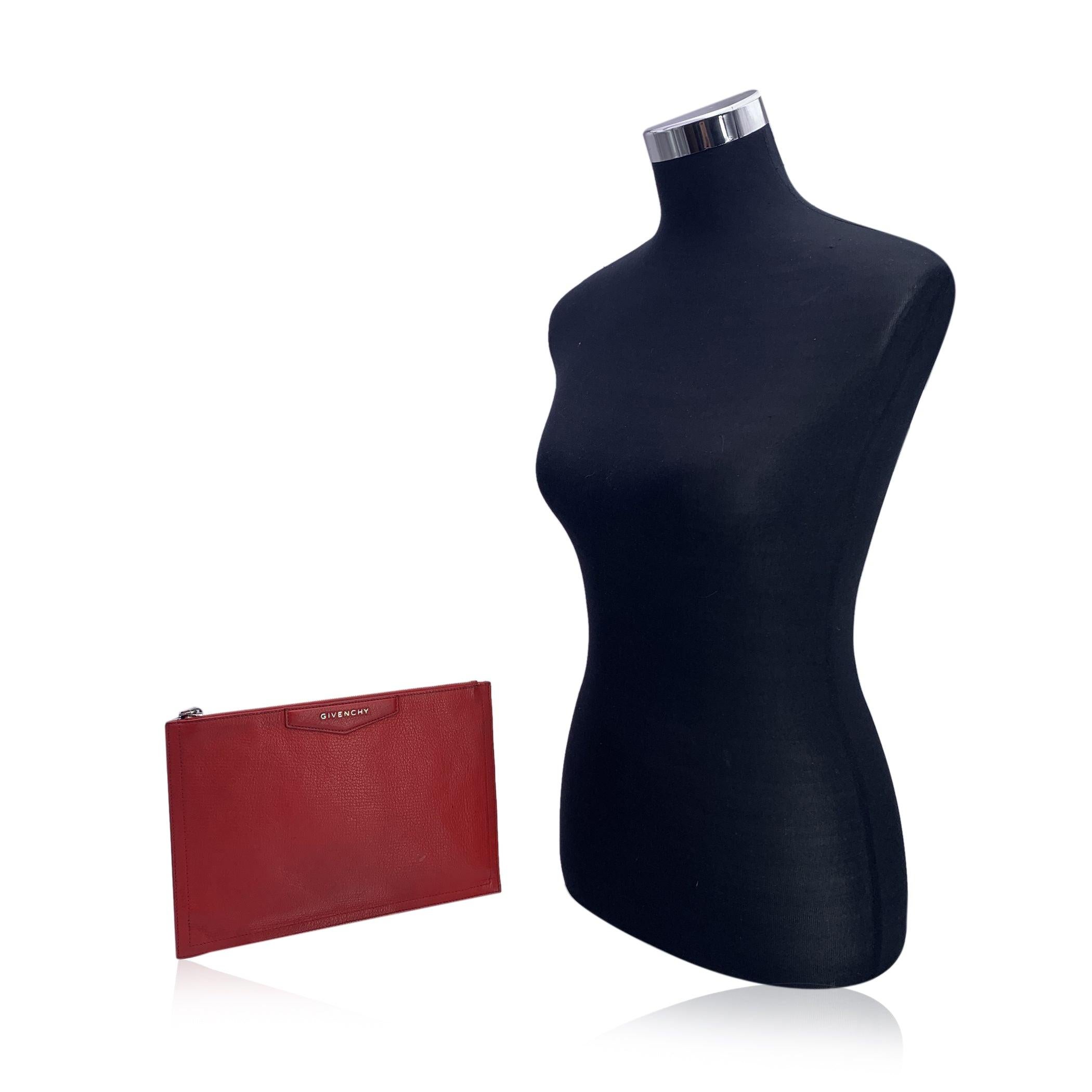 This beautiful Bag will come with a certificate of authenticity provided by third party authenticators. The certificate will be provided at no further cost. Givenchy 'Antigona' clutch bag, crafted in red leather. It features upper zipper closure and