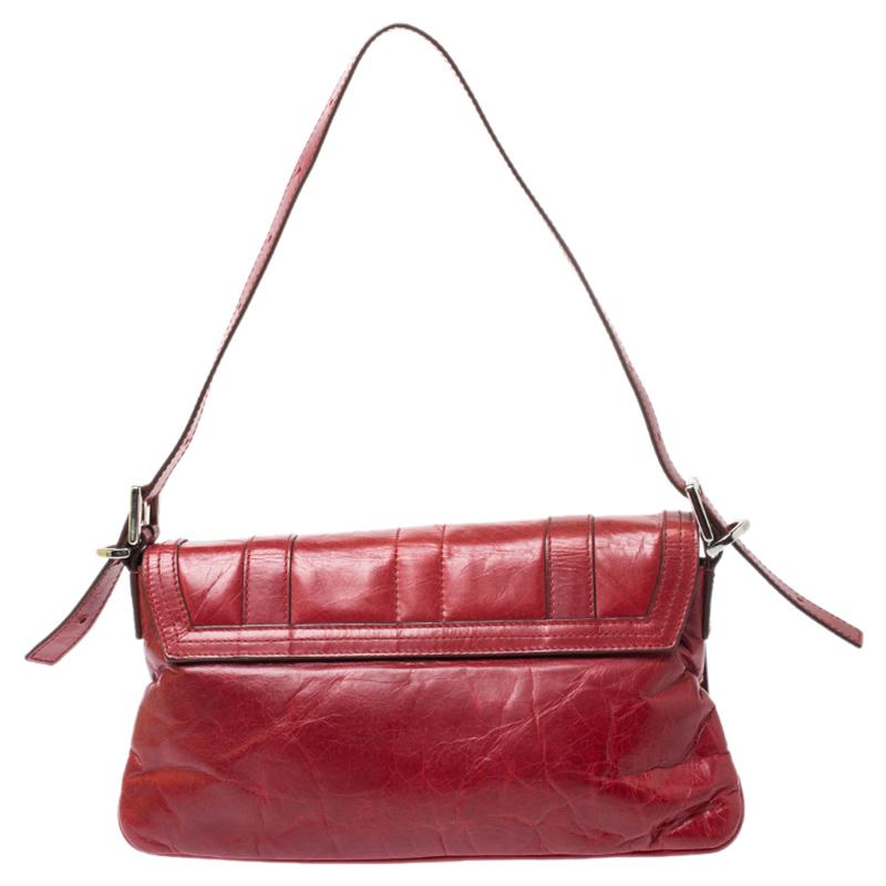 This striking shoulder bag from the house of Givenchy will elevate your outfits instantly. Crafted from leather, it comes in a lovely shade of red and flaunts a classic silhouette. It is held by a single handle, features a front flap with the brand