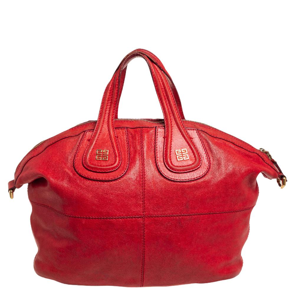 Excellently crafted from red leather, this Nightingale bag from Givenchy is a creation that is ideal for daily use and on your travels. It features two top handles, a shoulder strap, and a spacious fabric interior to dutifully hold your