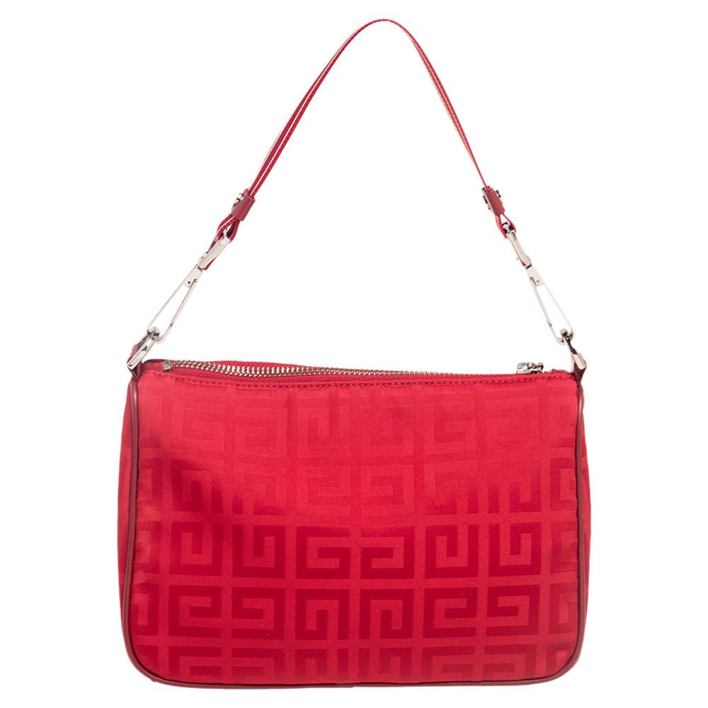This lovely baguette bag comes from the house of Givenchy. Crafted from the brand's signature nylon, it flaunts a lovely red hue. It is held by a single handle and features a zip closure that leads to a nylon-lined interior with enough space for
