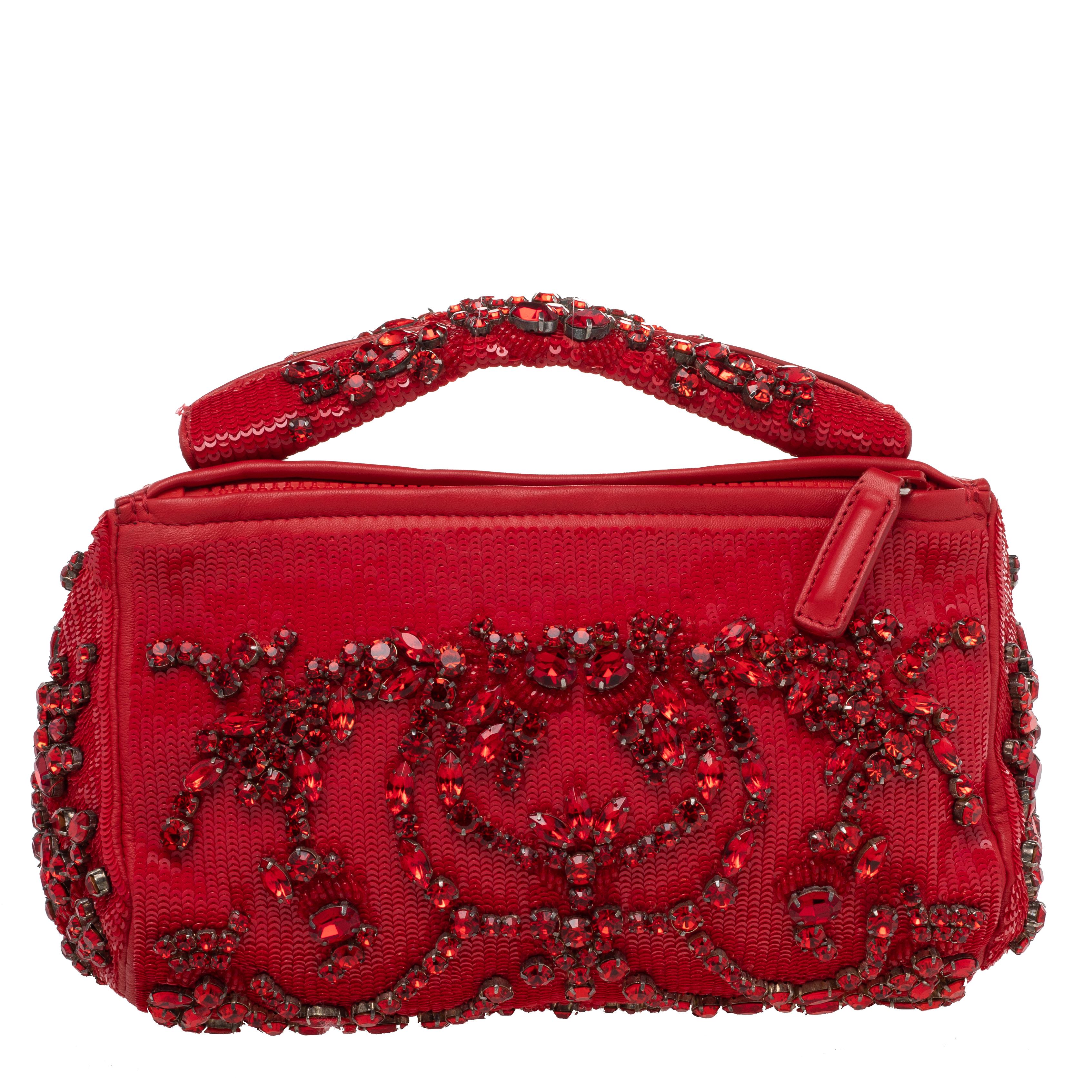 Made by Givenchy, this handbag is a perfect balance of elegance and practical utility. Simply sophisticated, this sequined bag flaunts beautiful crystal embellishments all over. Stow all your party essentials in the fabric and leather interior. It