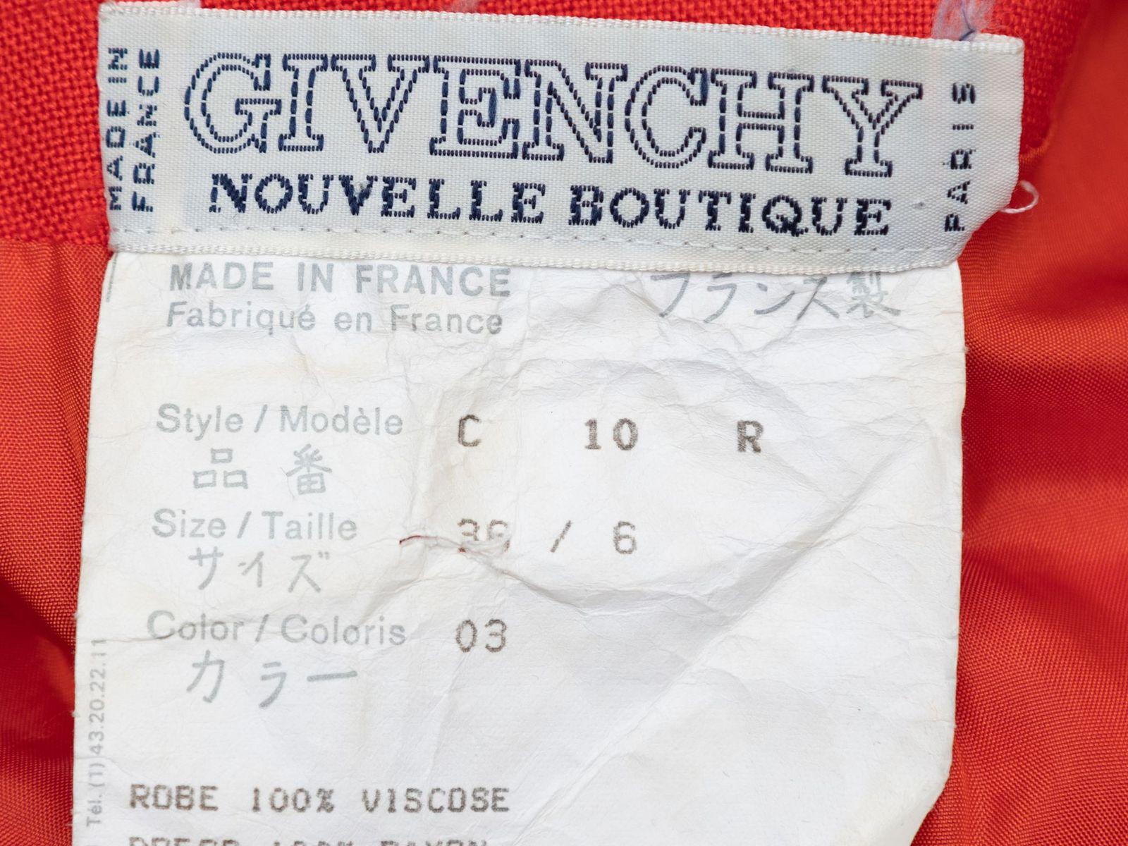 Product Details: Vintage red short sleeve dress by Givenchy. Notched collar. Gold-ton button closures at center front. 34