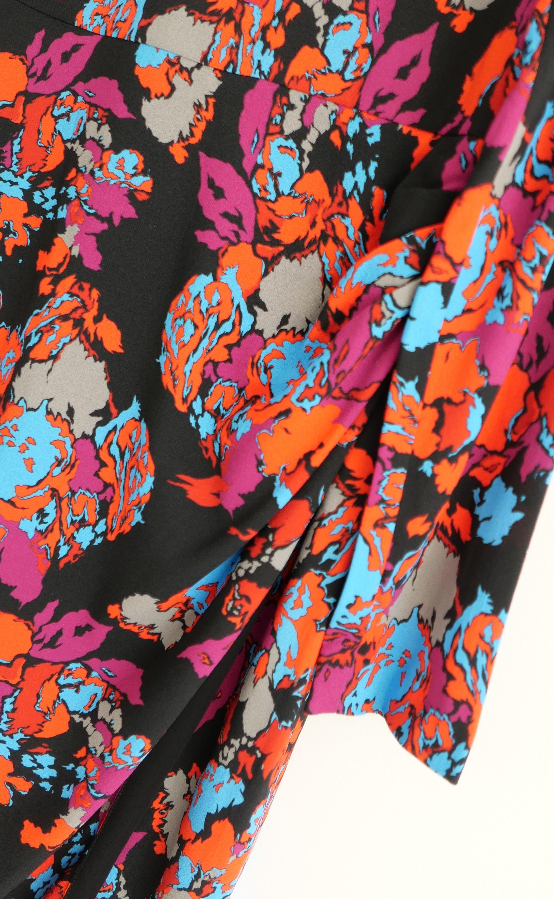Gorgeous Givenchy floral dress from the Resort 2019 collection.  Bought for £1250 and worn once. Made from black viscose and elastane crepe with a vivid stylised floral print. It has a faux wrap skirt with ruching to one hip, long sleeves and crew