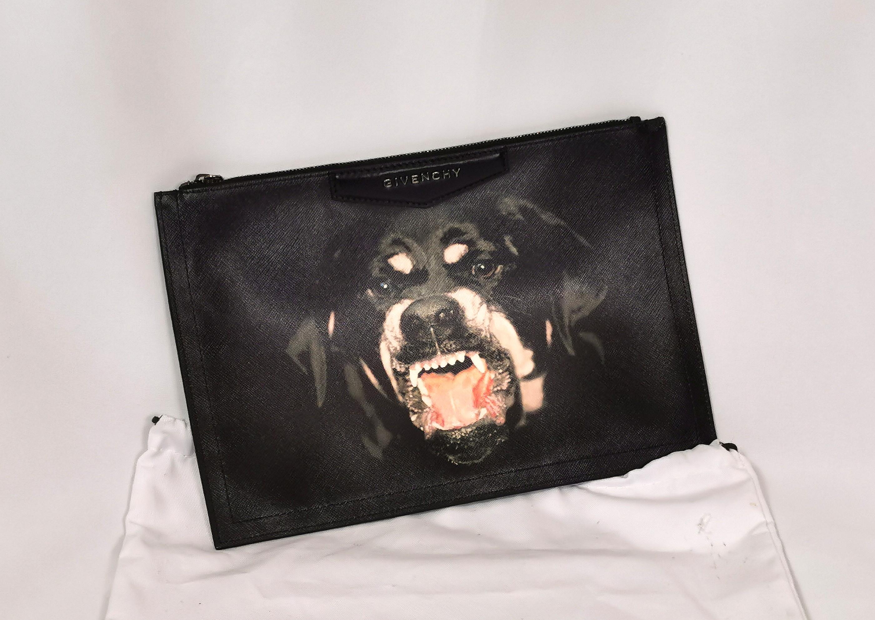 A gorgeous and iconic Givenchy Antigona rottweiler clutch bag.

This is the larger style clutch bag in textured printed leather with the iconic Givenchy rottweiler image.

It has a chunky metal and leather zipper fastening with a black cloth