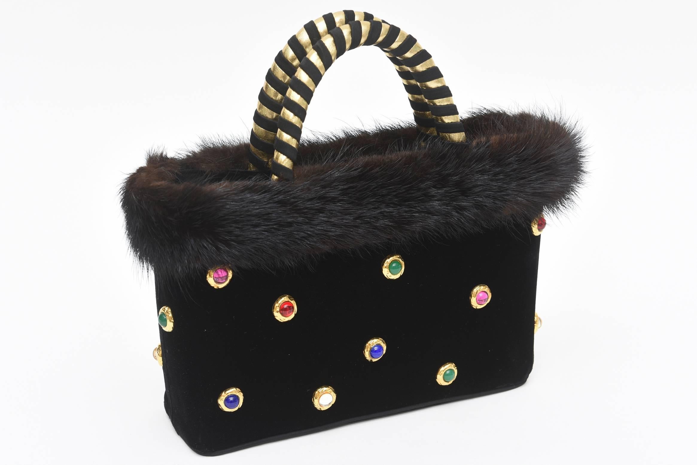 This rare and stellar ensemble set of vintage Givenchy of black doe skin (fine Suede) evening gloves set with colored stones and a velvet matching evening bag set with multi-colored stones will sure make any evening out a conversation place. The bag