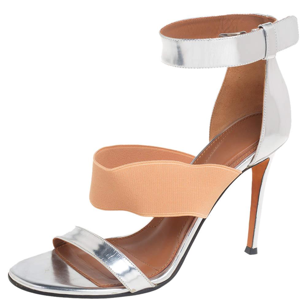 Get ready to look like a diva as you walk out in these sandals. With an exterior carved from silver foil leather and fabric, these sandals achieve a very glamorous appeal. The ankle-cuff is provided with a buckle. These sandals designed by Givenchy
