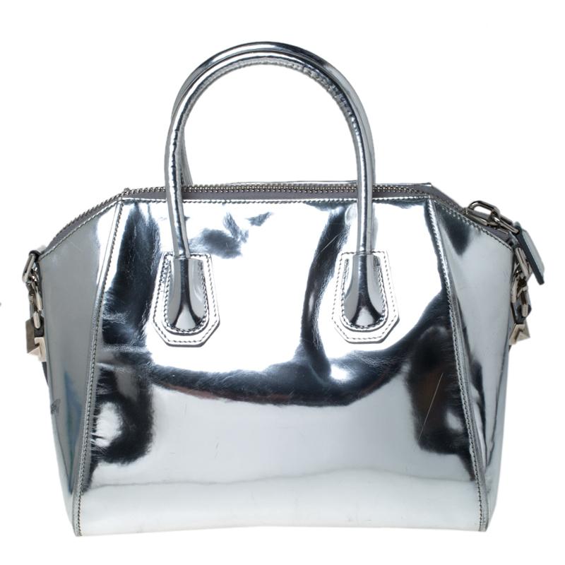 Made in Italy, and loved by women worldwide is this beautiful Antigona satchel by Givenchy. It has been crafted from leather and shaped elegantly. The silver bag has a top zipper that reveals a canvas interior and it is held by two top handles and a