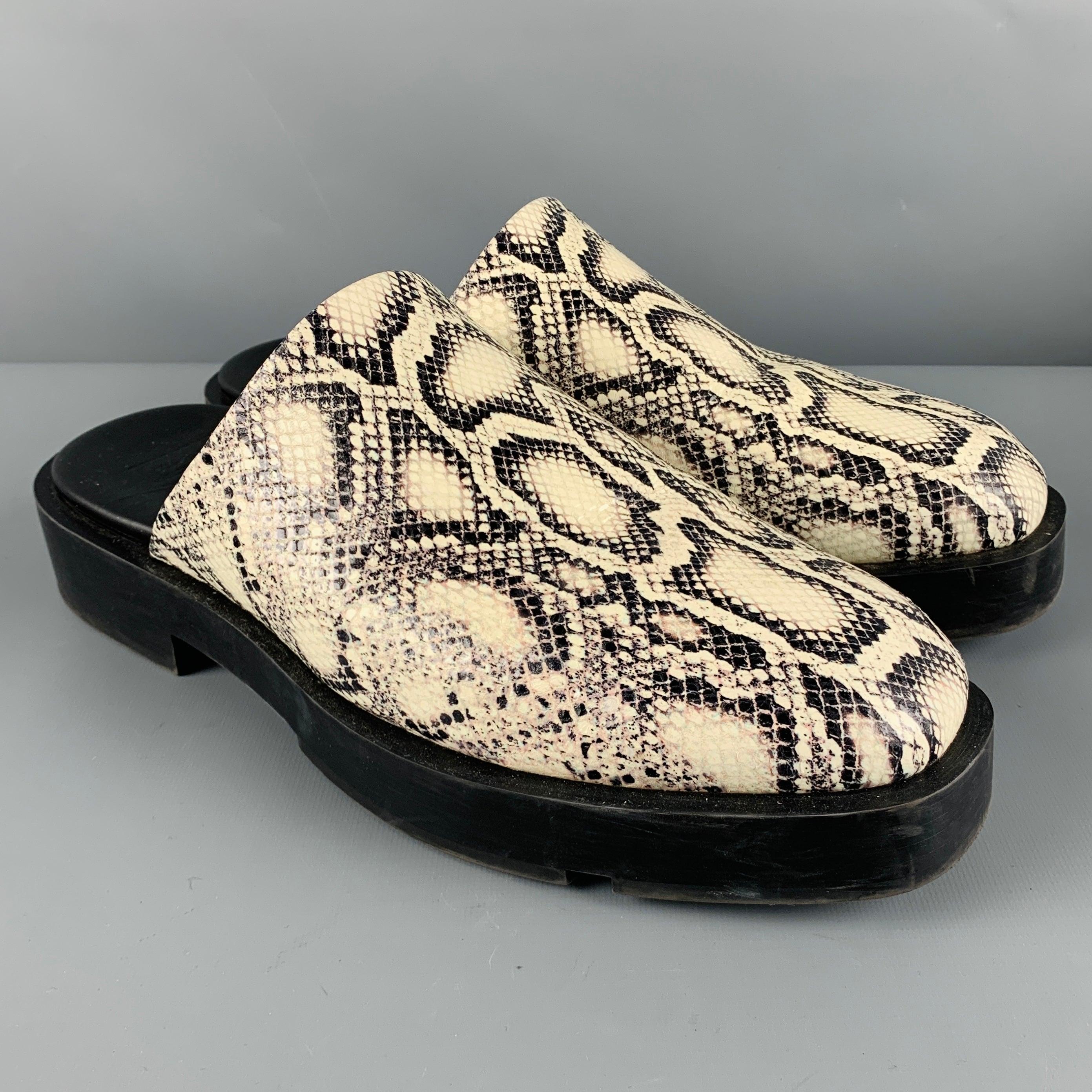 GIVENCHY loafers
in a white and black lambskin leather fabric featuring a snake print pattern, and backless slip on style. Comes with dust bag and box. Made in Italy.Excellent Pre-Owned Condition. 

Marked:   SA 0231 44 

Measurements: 
  
Outsole: