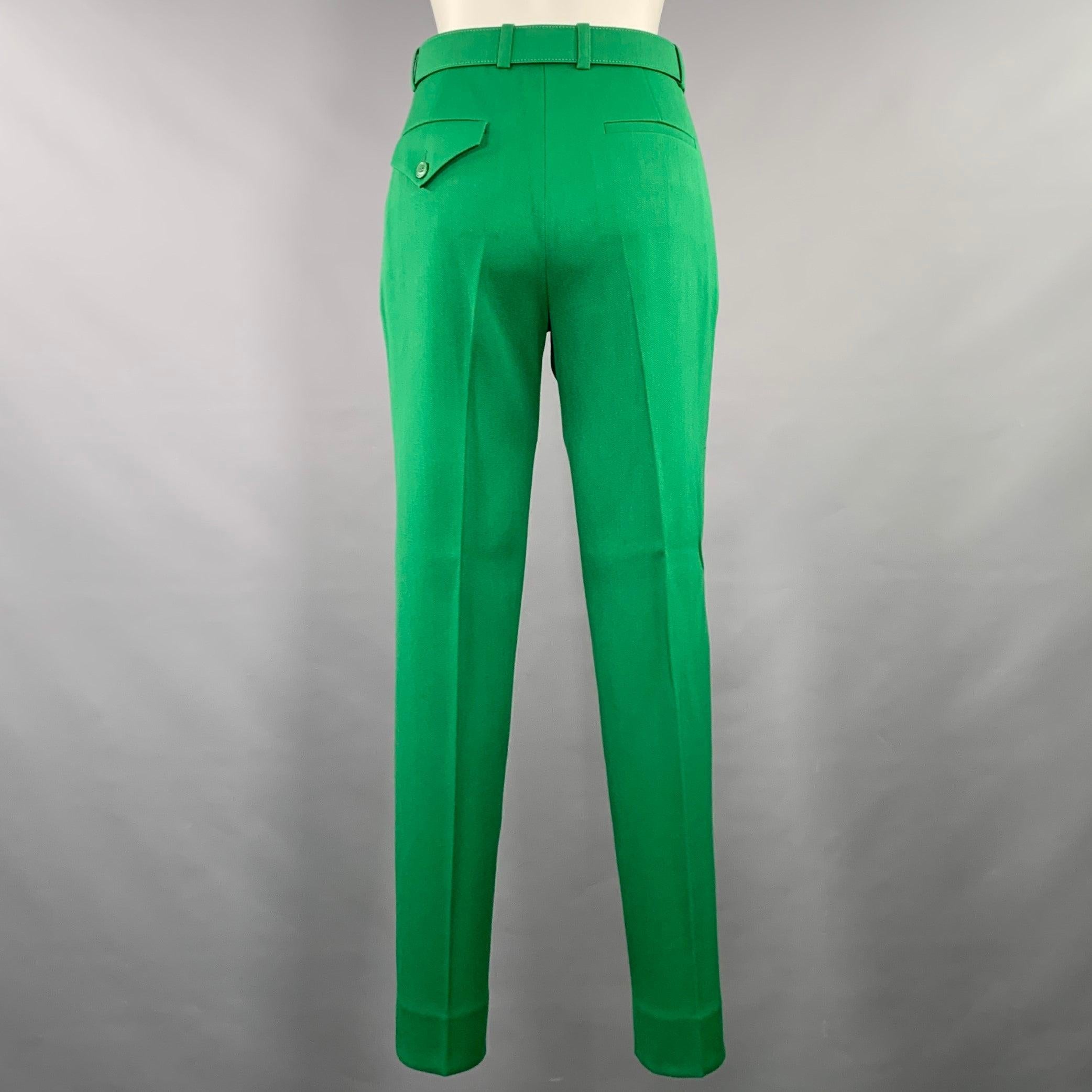 GIVENCHY dress pants
in a green polyester wool blend fabric featuring a belted style, narrow leg, and zip fly closure. Made in Italy.Excellent Pre-Owned Condition. 

Marked:   IT 34 

Measurements: 
  Waist: 28 inches Rise: 9.5 inches Inseam: 29