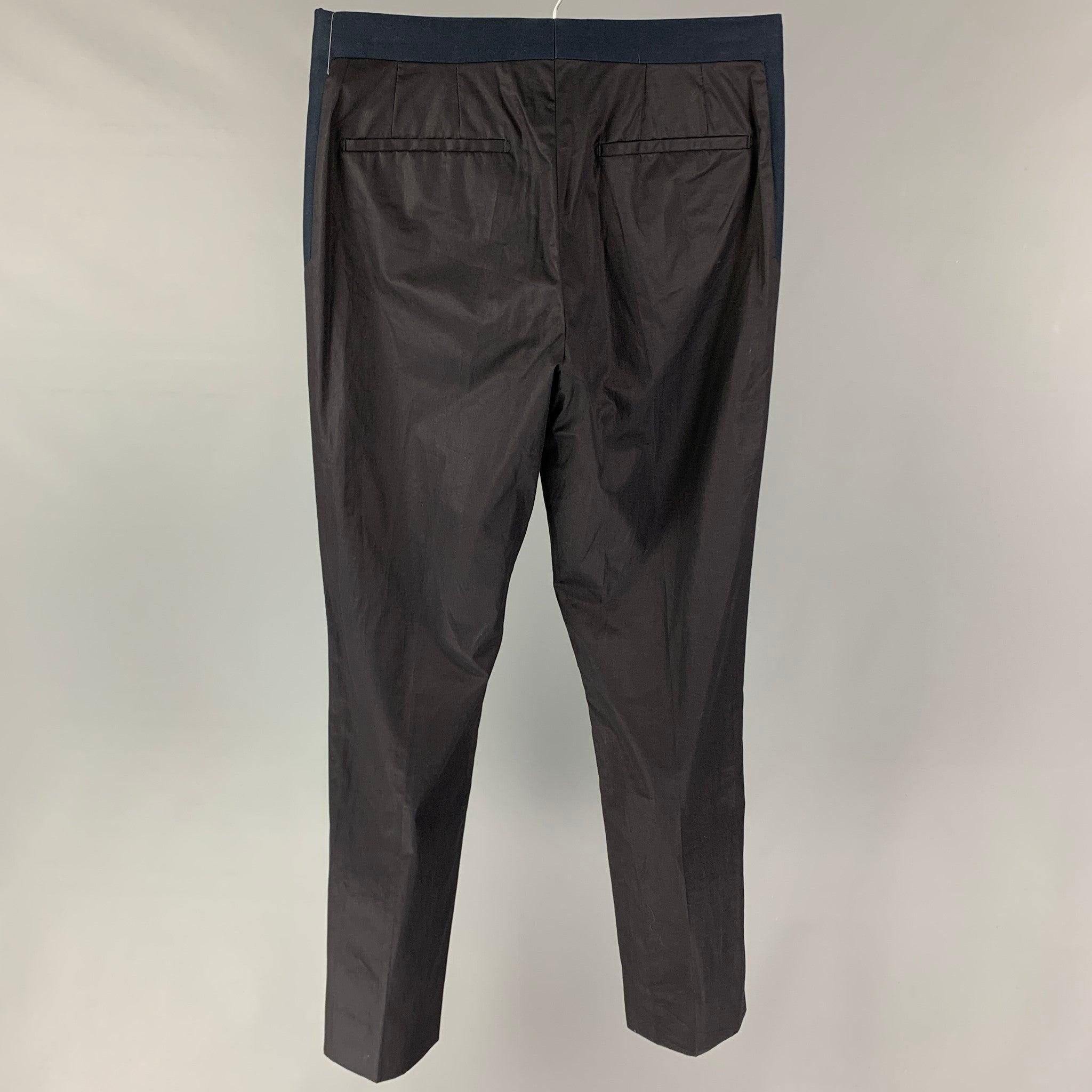 GIVENCHY dress pants comes in a black & navy cotton featuring a slim fit, front tab, and a zip fly closure. Made in Bulgaria.
Very Good
Pre-Owned Condition. 

Marked:   Size tag removed.  

Measurements: 
  Waist: 30 inches  Rise: 10 inches  Inseam: