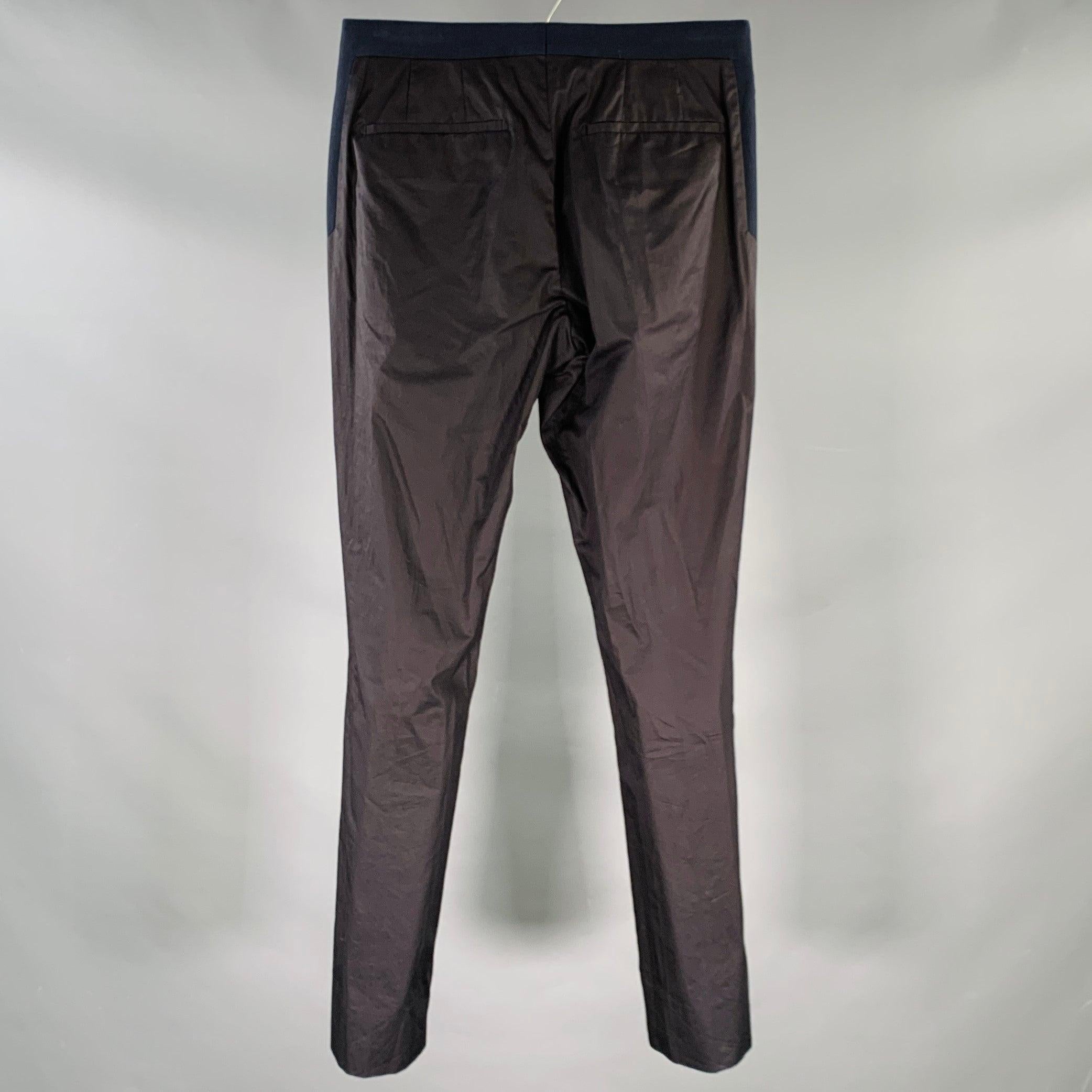 GIVENCHY dress pants
in a black and navy cotton woven fabric featuring a flat front style, back navy waistband detail, and zip fly closure. Very Good Pre-Owned Condition. Multiple minor hard-to-see marks. 

Marked:   size not marked 

Measurements: