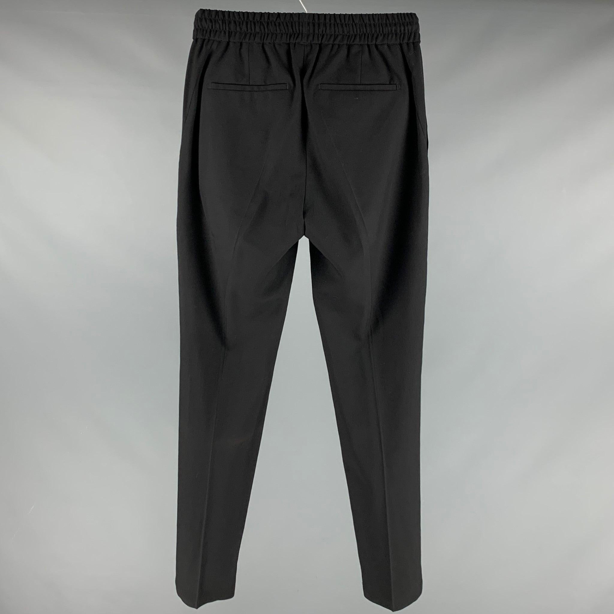 GIVENCHY casual pants
in a black wool fabric featuring elastic waistband, four pockets, and a zip fly closure. Made in Bulgaria.Very Good Pre-Owned Condition. Minor signs of wear. 

Marked:   46 

Measurements: 
  Waist: 30 inches Rise: 10 inches