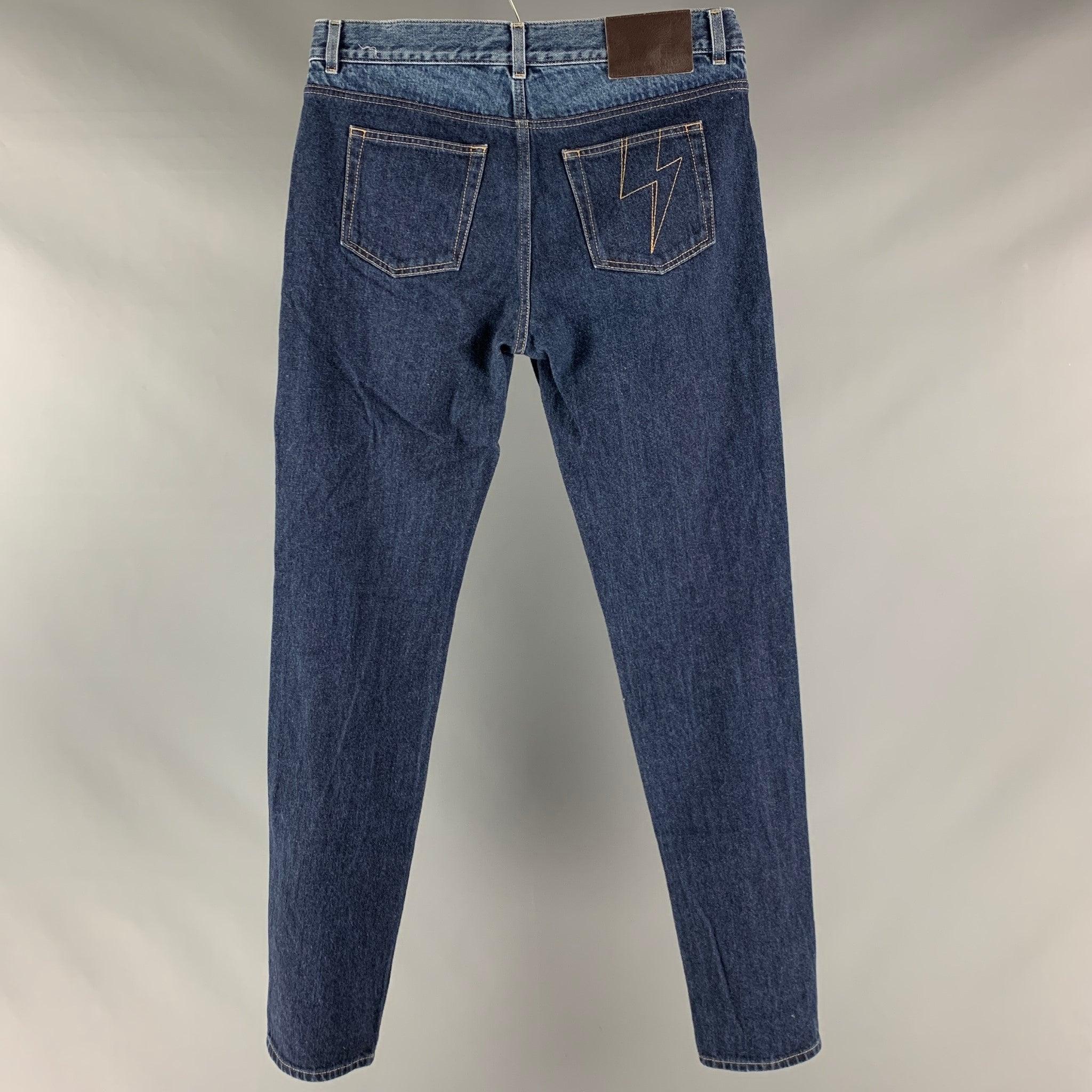 GIVENCHY jeans comes in an indigo denim selvedge featuring a color block, straight leg, contrast stitching, and a button fly closure. Made in Italy. Excellent Pre-Owned Condition. 

Marked:   32 

Measurements: 
  Waist: 32 inches Rise: 9 inches