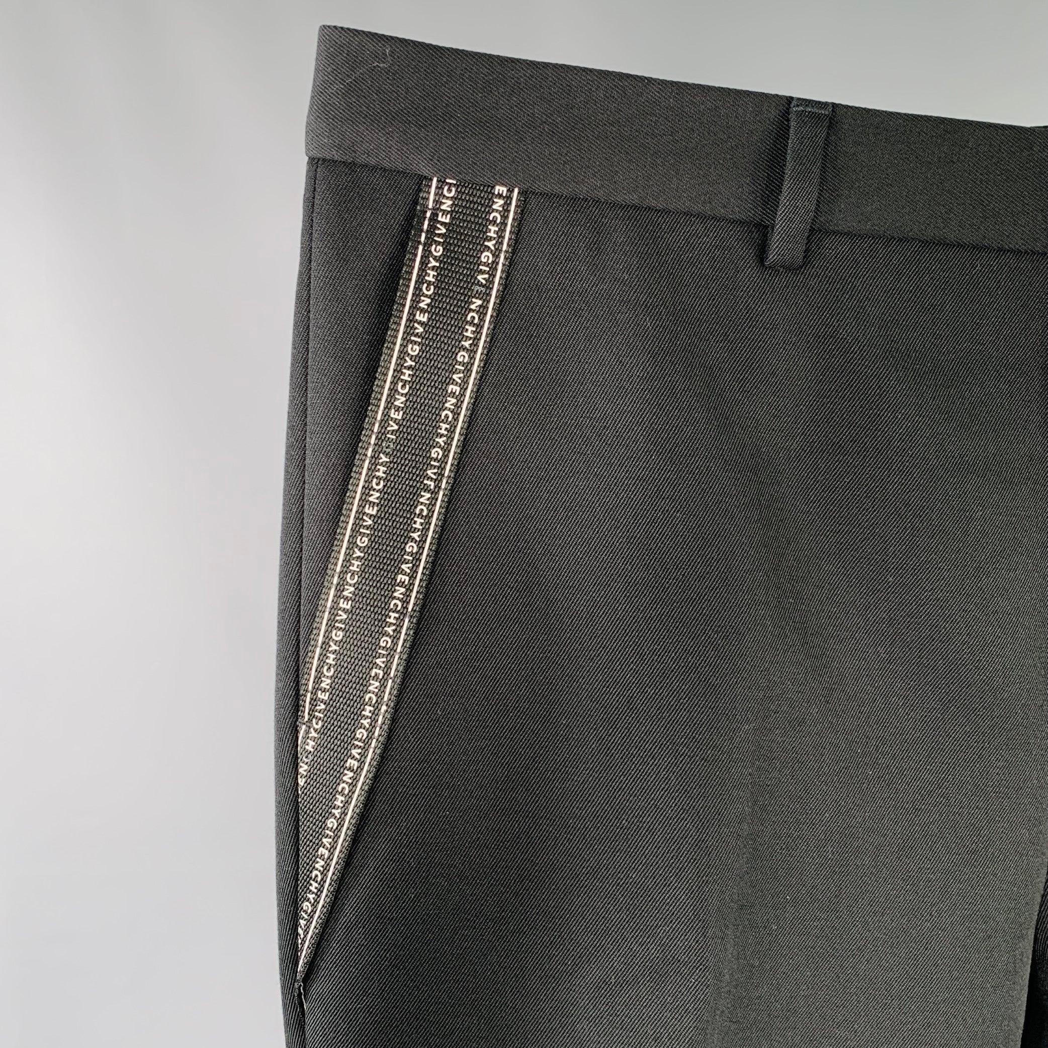 GIVENCHY dress pants
in a black polyester wool blend twill featuring black and white logo side strap details, tapered fit, and zip fly closure.Excellent Pre-Owned Condition. 

Marked:   IT 52 

Measurements: 
  Waist: 36 inches Rise: 9.5 inches