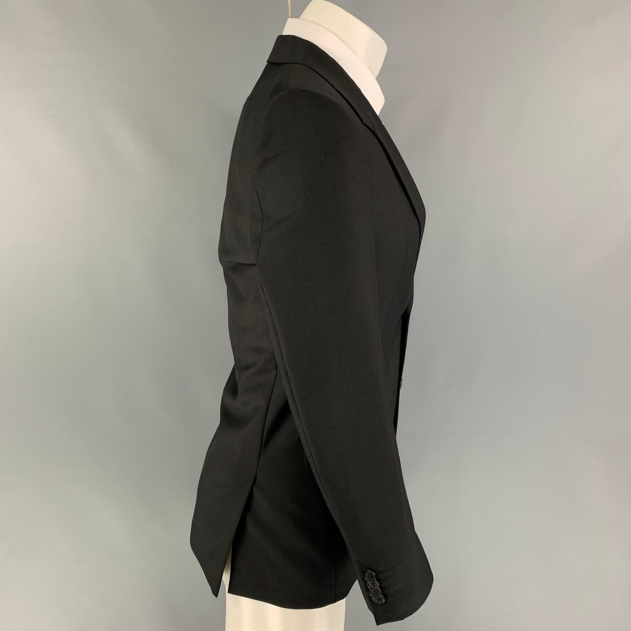 GIVENCHY sport coat comes in a black wool / mohair with a full liner featuring a structured lapel, flap pockets, double back vent, and a double button closure.
Excellent
Pre-Owned Condition. 

Marked:   46 

Measurements: 
 
Shoulder: 17 inches 