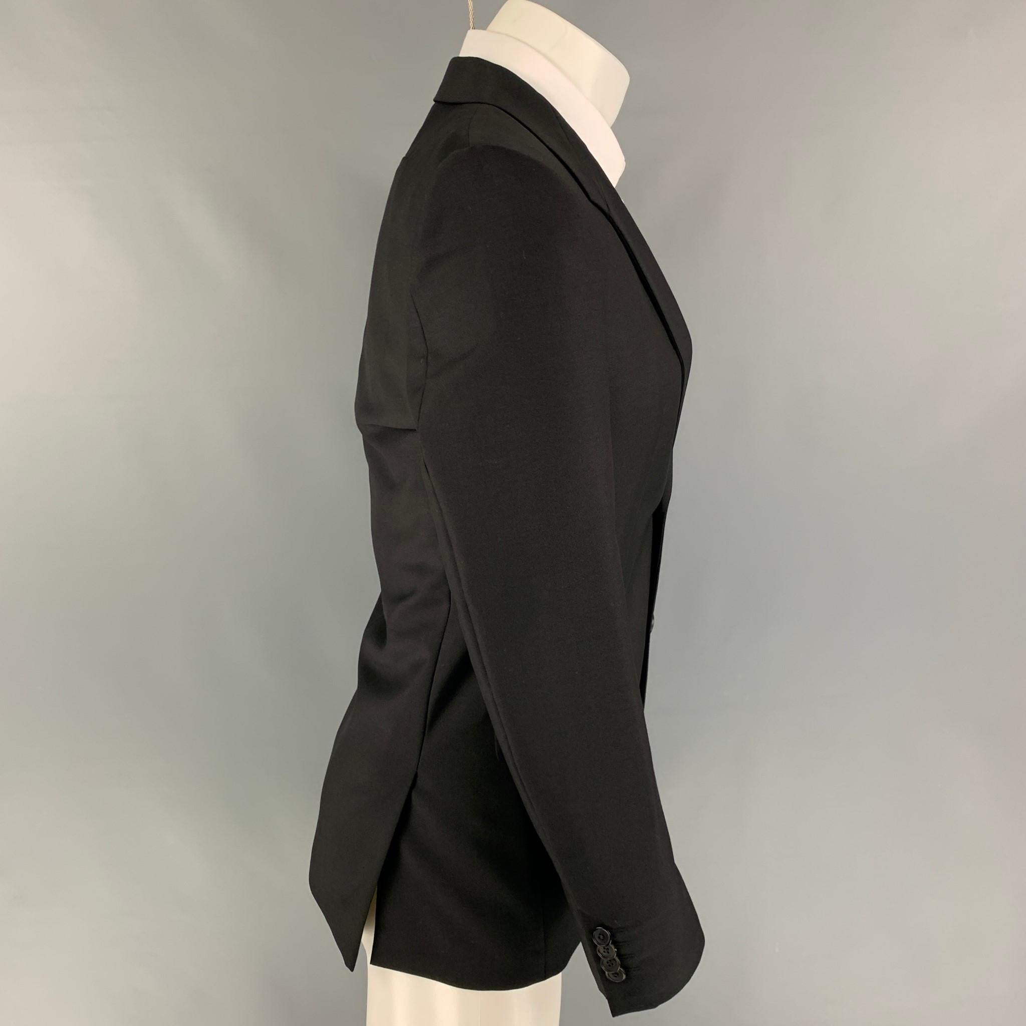 GIVENCHY sport coat comes in a black wool / mohair with a full liner featuring a structured lapel, flap pockets, double back vent, and a double button closure. 

Excellent Pre-Owned Condition.
Marked: 46

Measurements:

Shoulder: 17 in.
Chest: 36