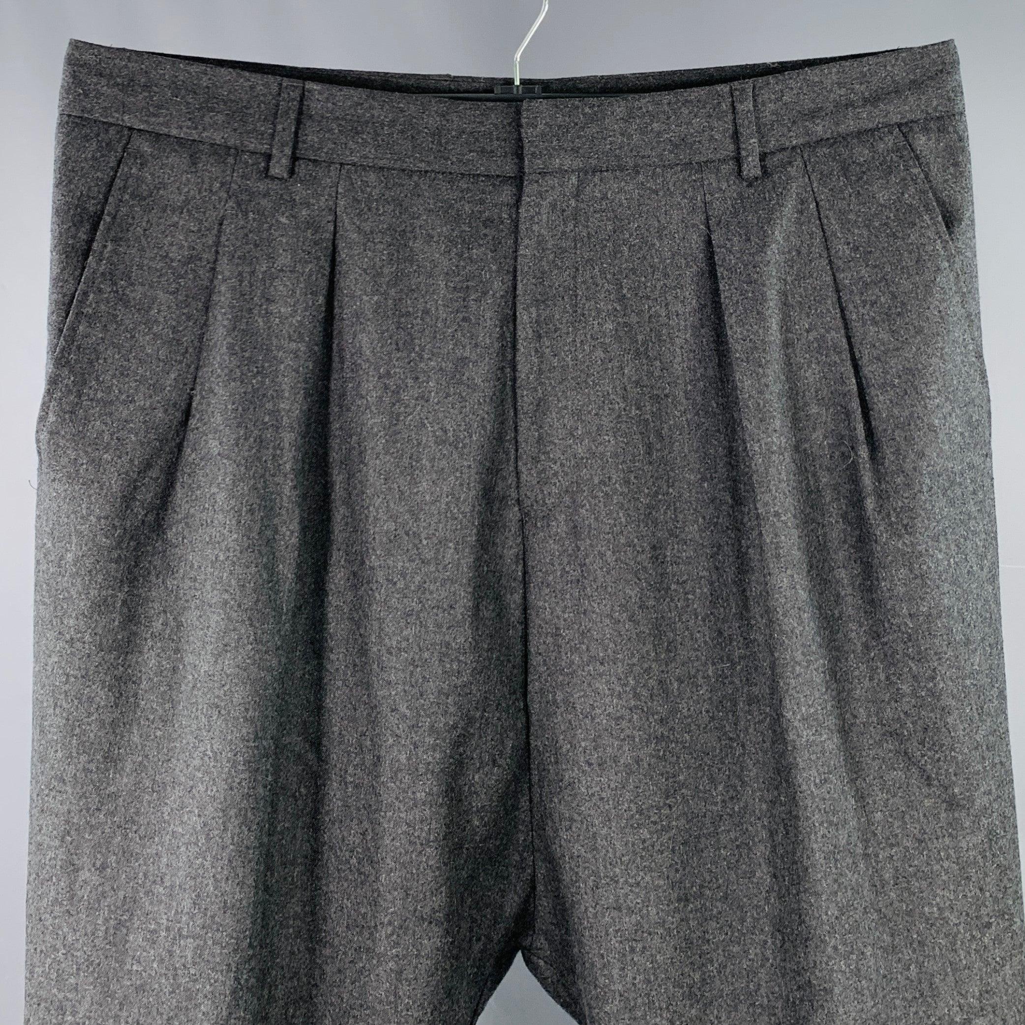 GIVENCHY dress pants
in a charcoal grey wool featuring a pleated style, tapered fit, and zip fly closure. Hem has been left unfinished in order to tailor to your perfect fit. Made in Bulgaria.Excellent Pre-Owned Condition. 

Marked:   size not
