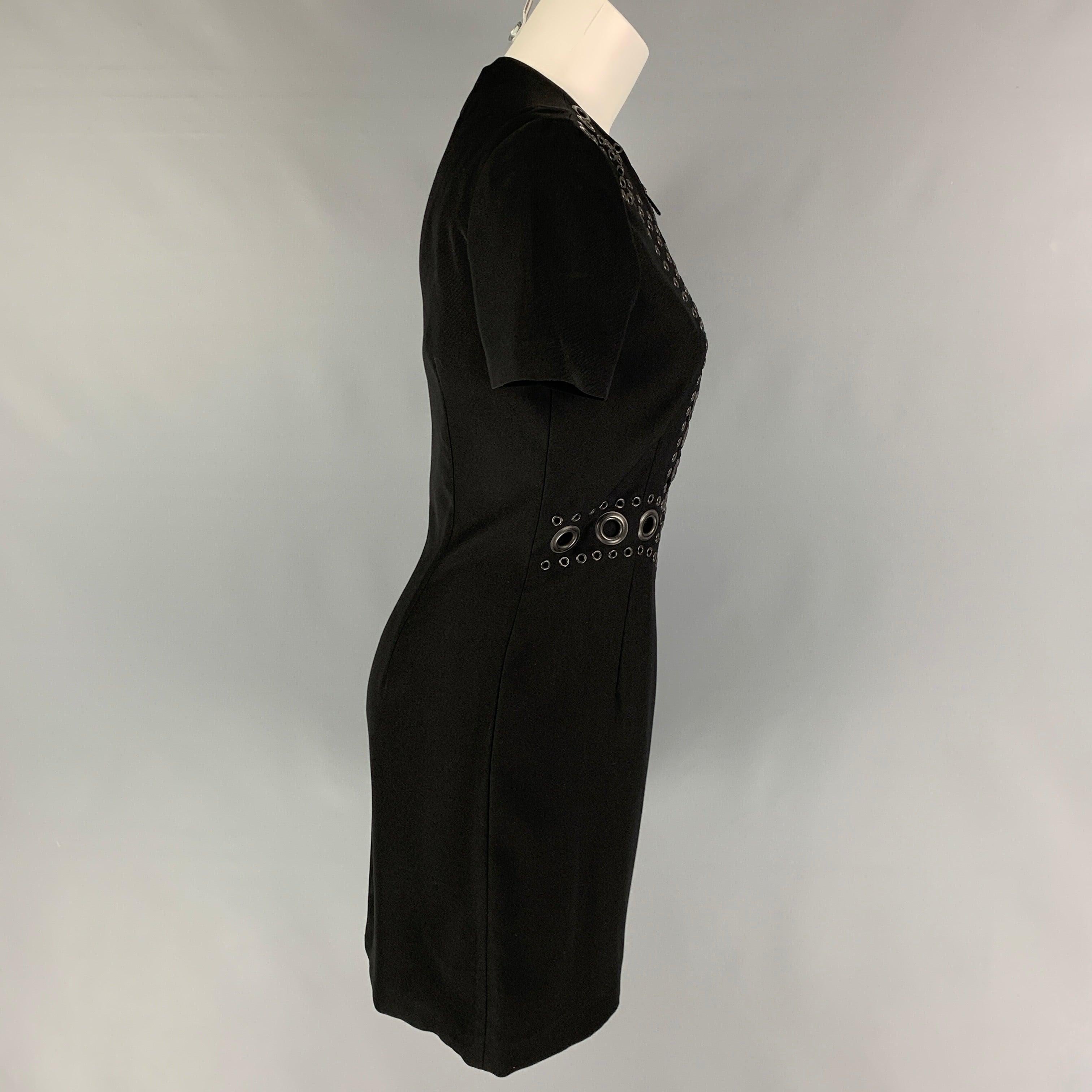 GIVENCHY dress comes in a black polyester featuring gunmetal grommet details at front, short sleeves, and a front half zip up closure.
Very Good
Pre-Owned Condition. 

Marked:   40 

Measurements: 
 
Shoulder: 15 inches  Bust: 33 inches  Waist: 28