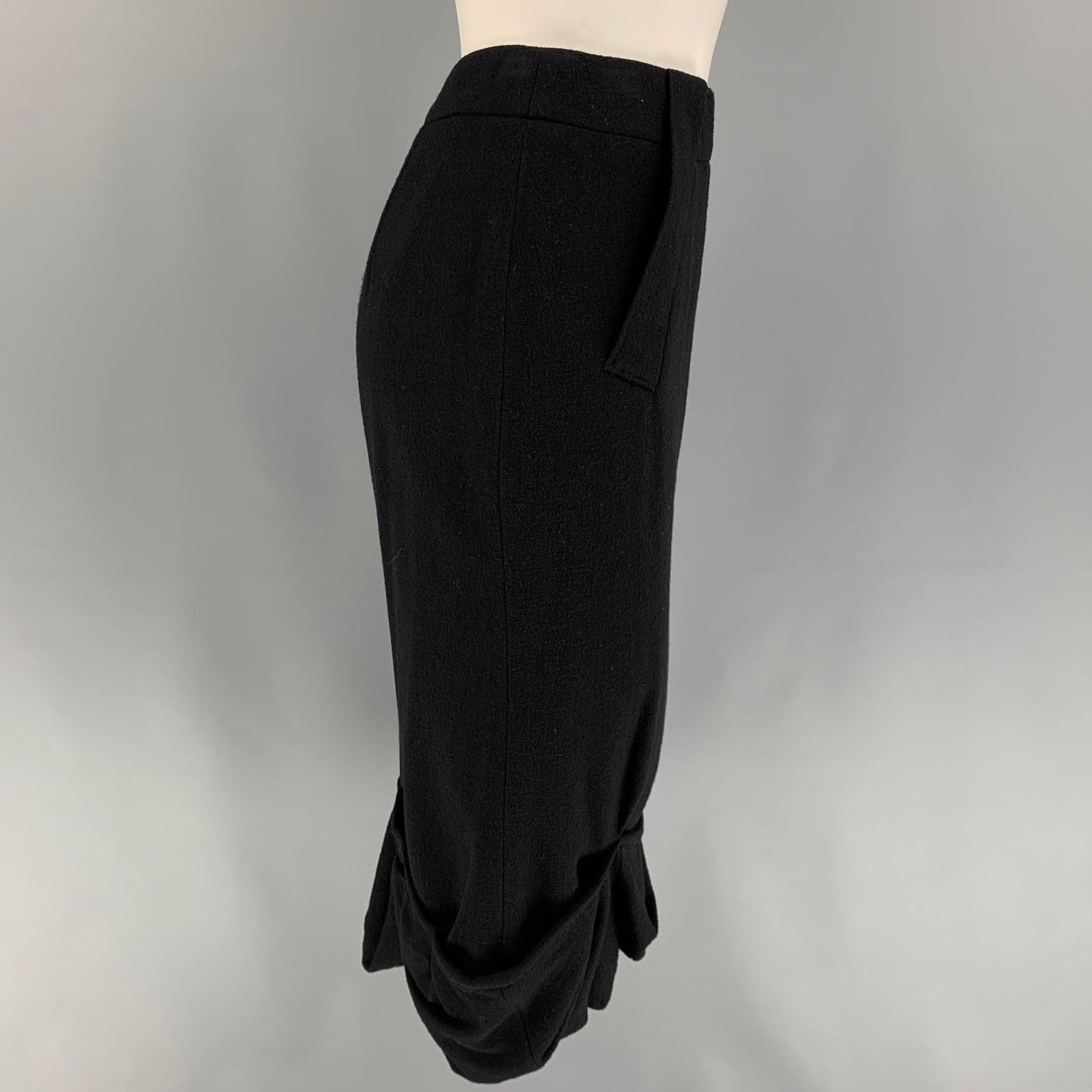 GIVENCHY skirt comes in a black wool featuring a ruffled hem, pencil style, and a back zip up closure. Made in Italy.
Very Good
Pre-Owned Condition. 

Marked:   36 

Measurements: 
  Waist: 27 inches  Hip: 32 inches  Length: 29 inches 
  
  
