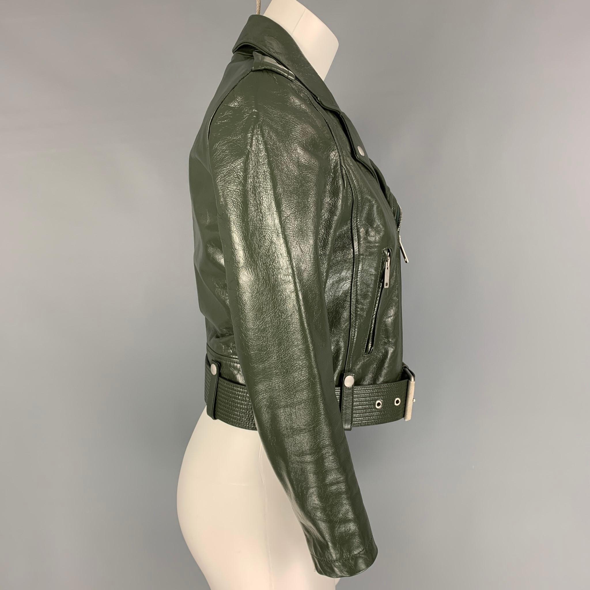 GIVENCHY jacket comes in a green calfskin leather with a full print liner featuring a biker style, epaulettes, silver tone hardware, front pockets, belted, zipped sleeves, and a zip up closure. Made in Romania. 

Excellent Pre-Owned