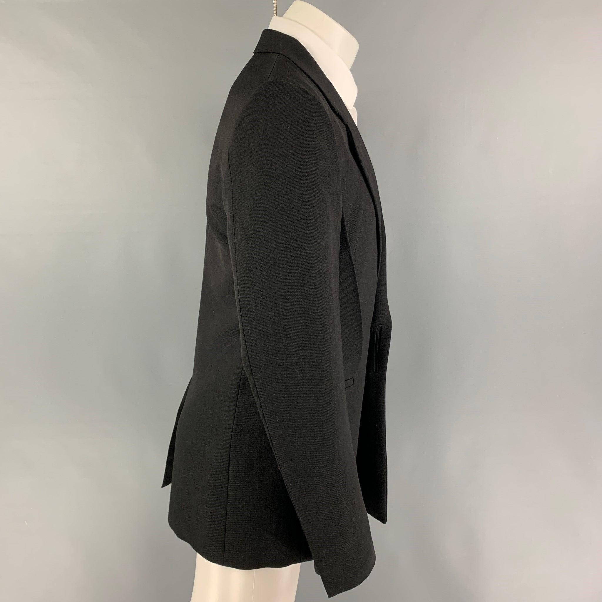 GIVENCHY sport coat comes in a black material with a full liner featuring a slim fit, notch lapel, two front pleats, slit pockets, single back vent, and a single button closure.
Very Good
Pre-Owned Condition. Fabric tag removed.  

Marked:   Size