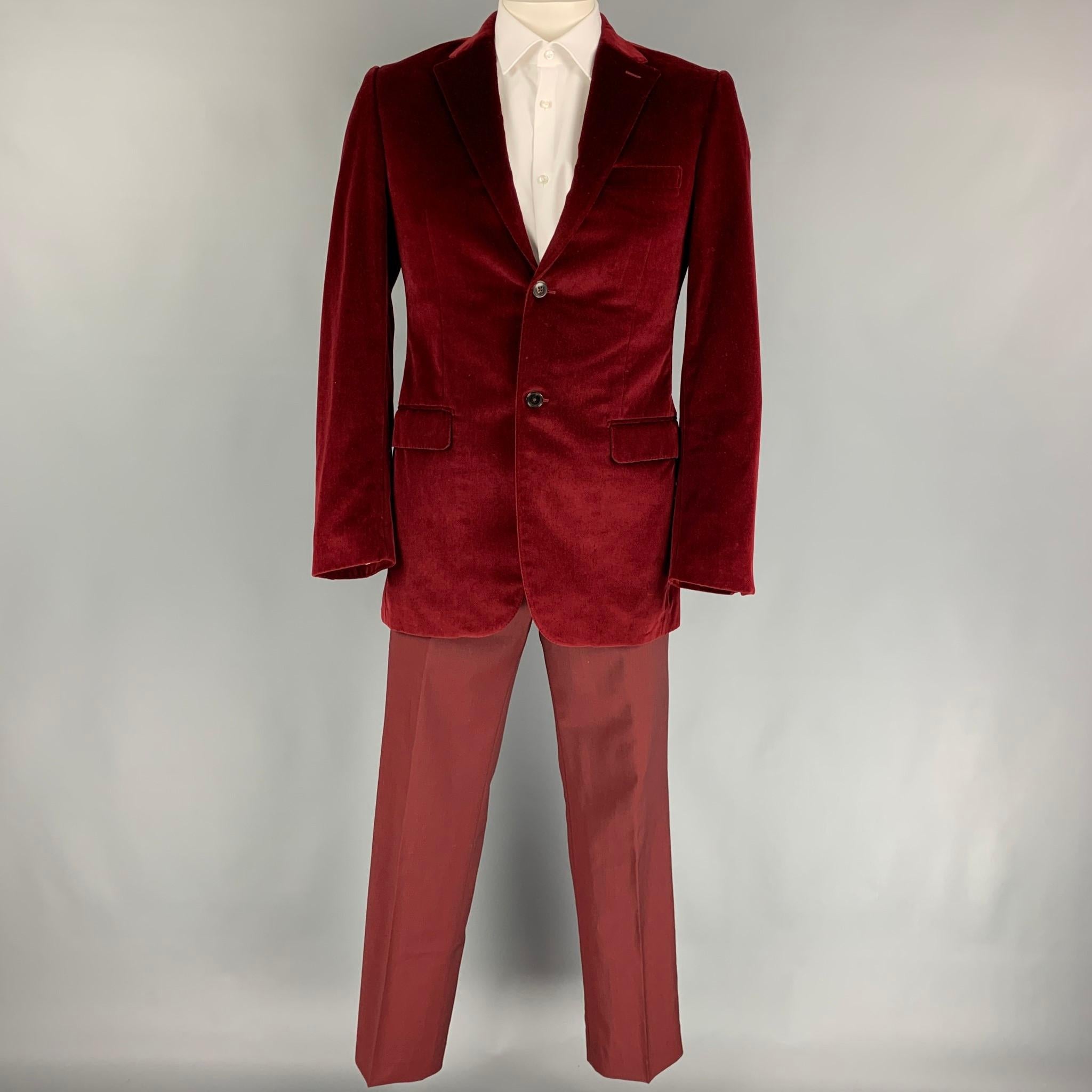 GIVENCHY suit comes in a burgundy velvet with a full liner and includes a single breasted, double button sport coat with a notch lapel and matching flat front trousers. Made in Italy.

Excellent Pre-Owned Condition.
Marked: 50