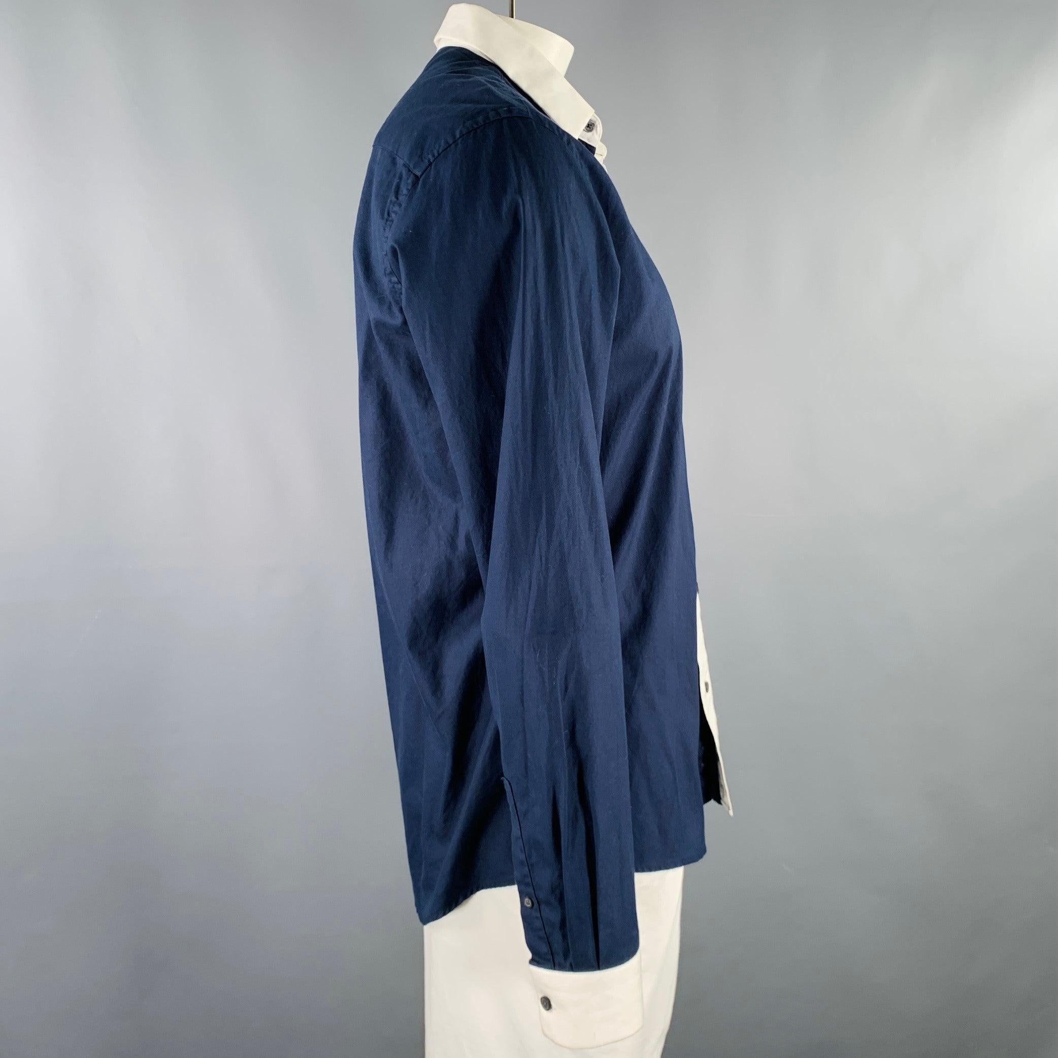 GIVENCHY long sleeve shirt
in a navy cotton woven fabric featuring white contrasting trim, spread collar, and button closure.Excellent Pre-Owned Condition. 

Marked:   16.5/42 

Measurements: 
 
Shoulder: 18 inches Chest: 44 inches Sleeve: 26.5