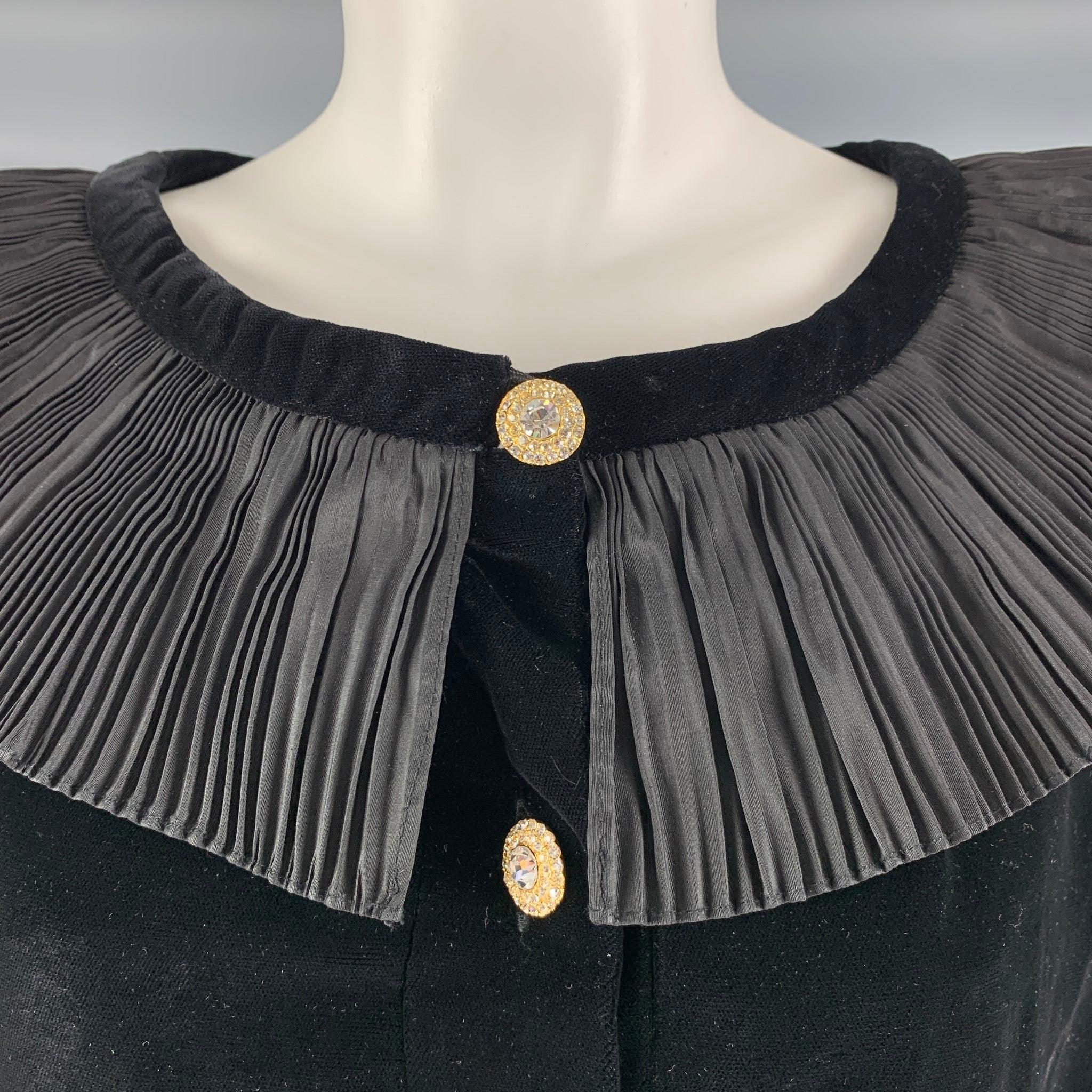 Vintage GIVENCHY top comes in black Viscose and Rayon velvet,featuring a pleated collar, shoulder pads, zipper cuffs, and a button up closure.
 Made in France.Excellent Pre-Owned Condition. 

Marked:   6 

Measurements: 
 
Shoulder: 15 inches Bust: