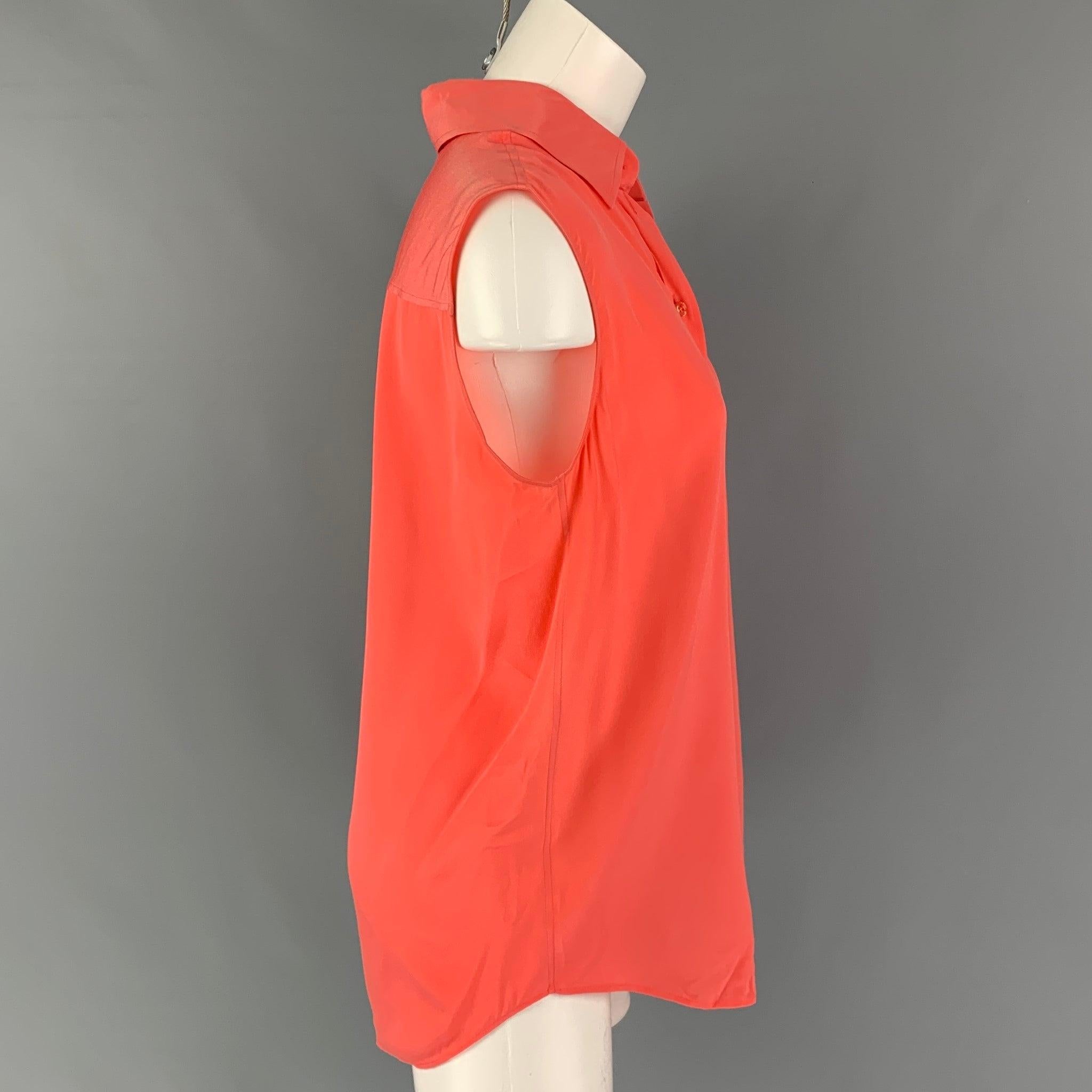 GIVENCHY blouse comes in a coral silk featuring a sleeveless style, spread collar, and a button up closure.
Very Good
Pre-Owned Condition. 

Marked:   38 

Measurements: 
 
Shoulder: 15.5 inches  Bust: 40 inches  Length: 28 inches 
  
  
