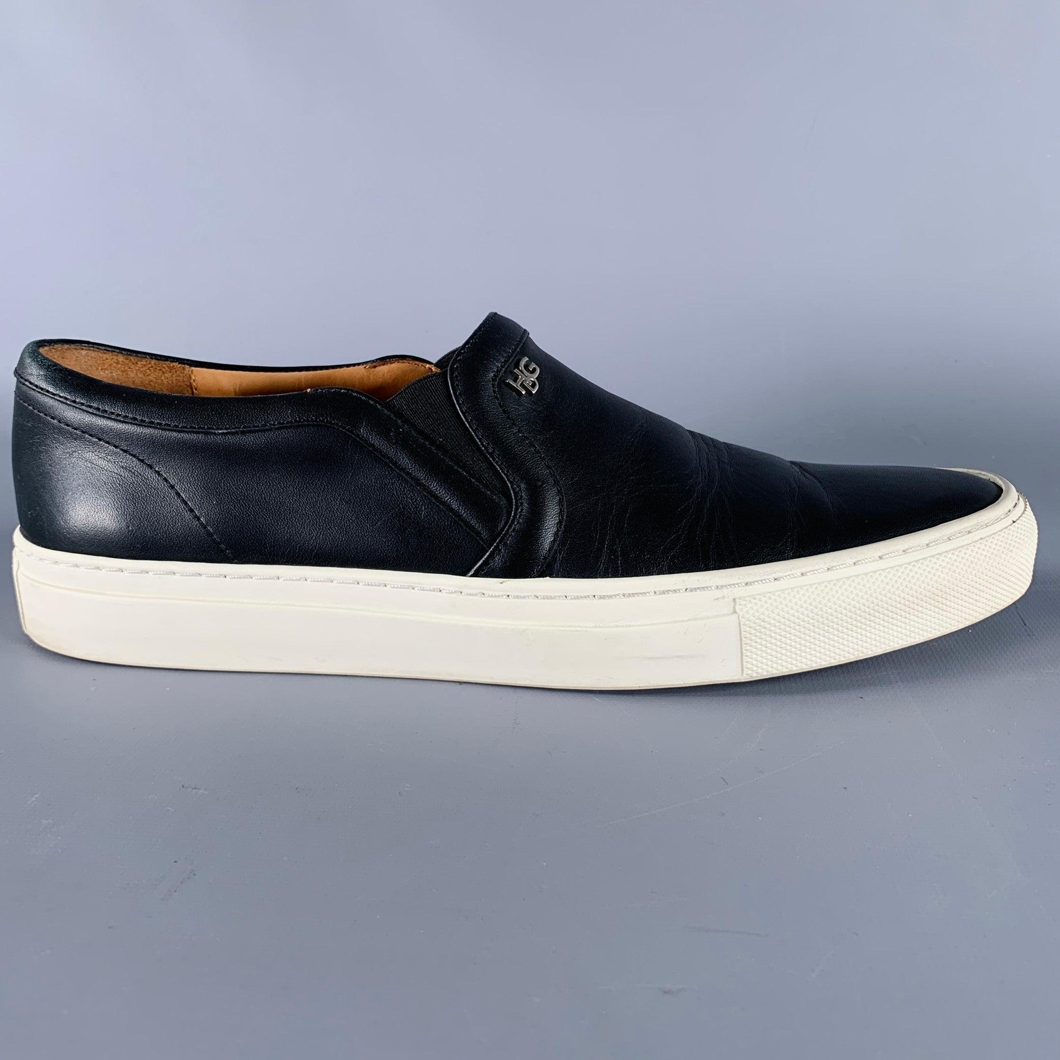 GIVENCHY sneakers
in a black leather fabric featuring a white non-slip rubber sole, and slip on closure. Made in Portugal.Very Good Pre-Owned Condition. Minor signs of wear. 

Marked:   14M8010811 0114 41Outsole: 11 inches  x 4 inches 
  
  
 
Sui