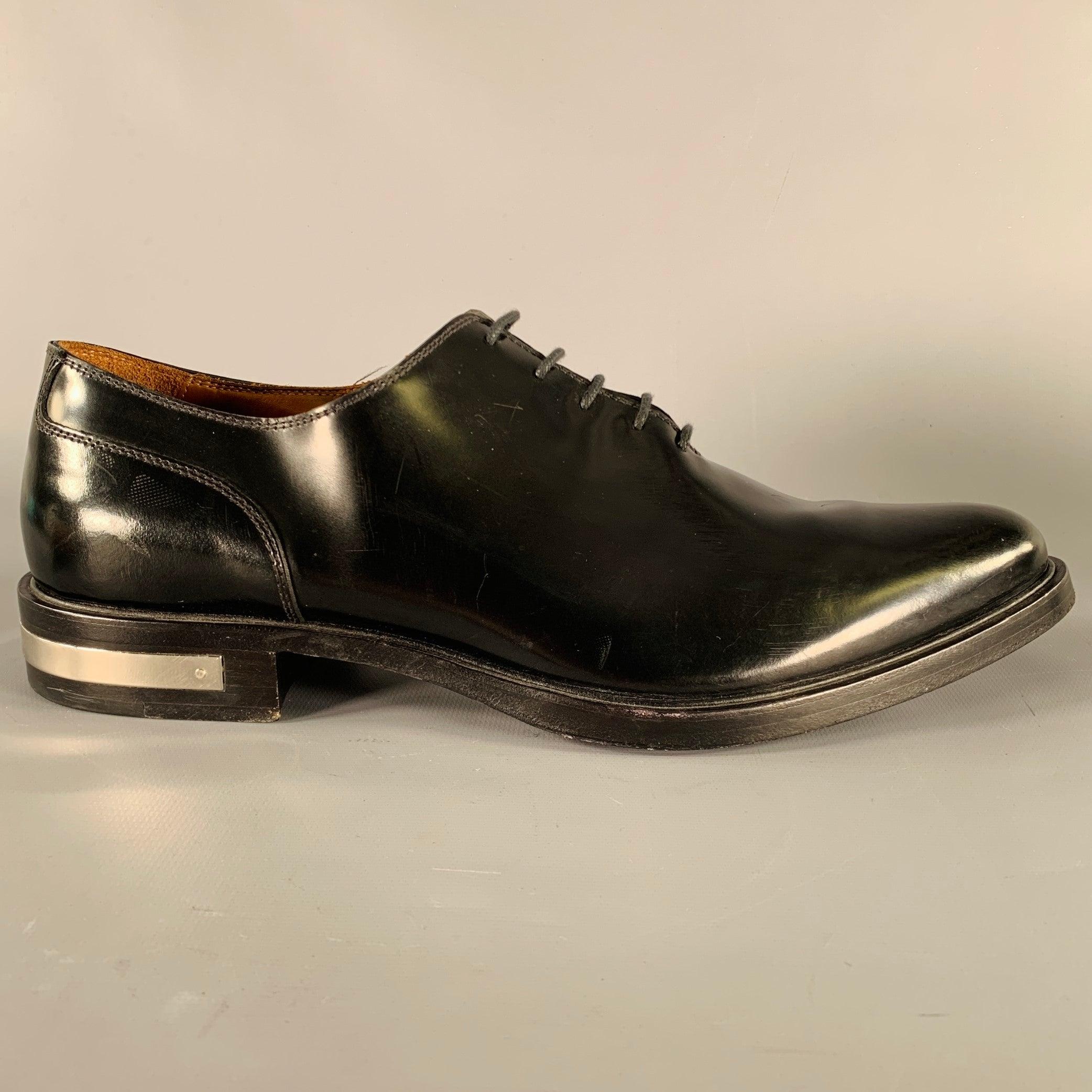 GIVENCHY shoes
in a black leather fabric featuring an oxford style, metal heel trim detail, and lace-up closure. Made in Italy.Very Good Pre-Owned Condition. Signs of wear on heel trim. 

Marked:   BM08008 42Outsole: 12 inches  x 4.25 inches 
  
  
