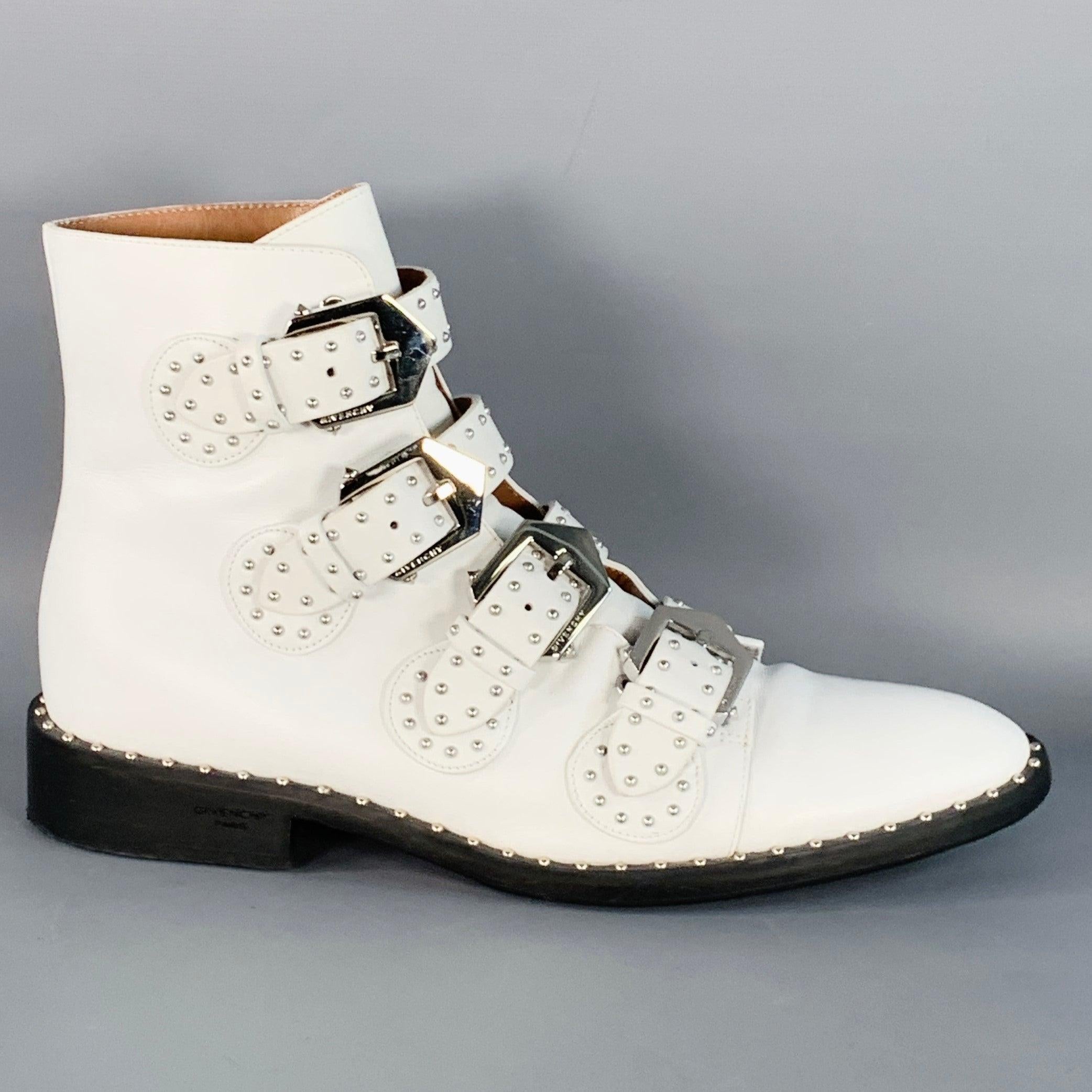 GIVENCHY boots in a white leather featuring a silver tone metal studded design, and silver tone metal buckle closure. Made in Italy.Good Pre-Owned Condition. Moderate creasing and signs of wear. 

Marked:   ES 1107
 

Measurements: 
  Length: 11