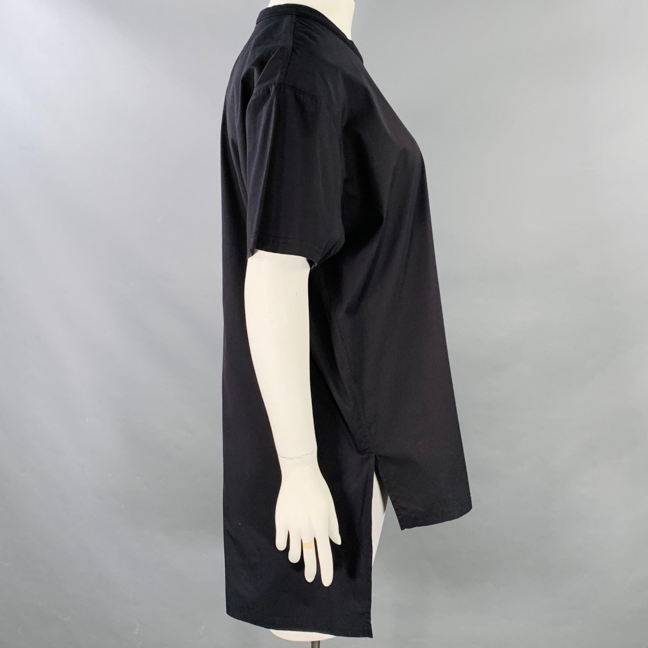 GIVENCHY t-shirt
in a black cotton jersey featuring short sleeves, crew neck, and shoulder zip closure. Excellent Pre-Owned Condition. 

Marked:   L 

Measurements: 
 
Shoulder: 20.5 inches Bust: 48 inches Sleeve: 8.5 inches Length: 35 inches  
 
 