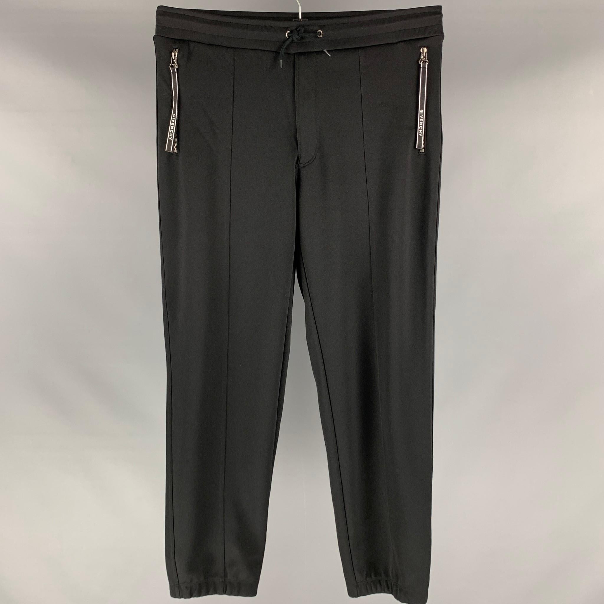 GIVENCHY sweatpants comes in a black cotton polyester jersey knit fabric featuring a logo trim detail, zip up pockets, elastic waist, and a drawstring.

Excellent Pre-Owned Condition.
Marked: L

Measurements:

Waist: 33 in.
Rise: 13 in.
Inseam: 30