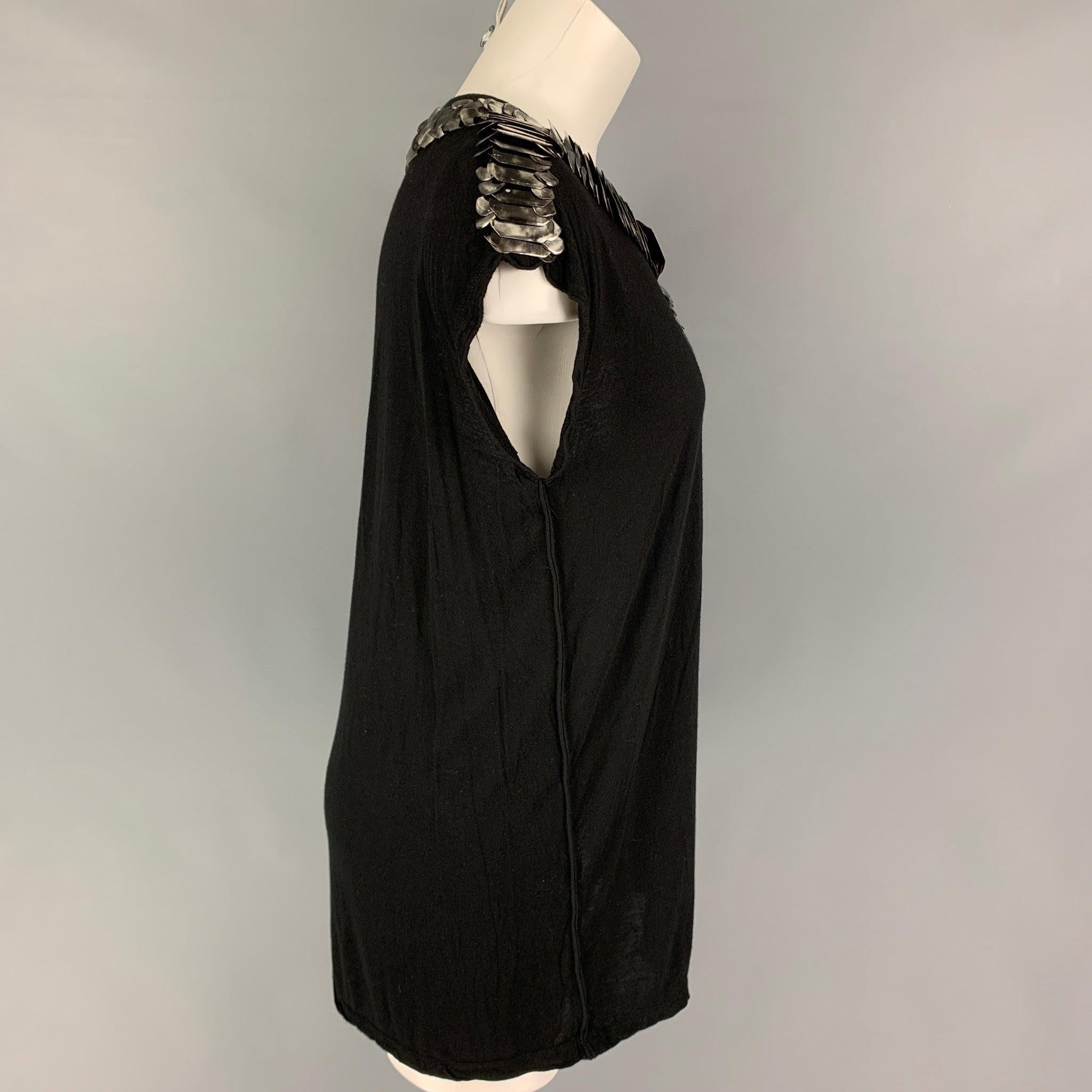 GIVENCHY t-shirt comes in a black viscose featuring a sleeveless style, silver tone applique details, and a crew-neck.
Very Good
Pre-Owned Condition. 

Marked:   M  

Measurements: 
 
Shoulder: 19 inches  Bust: 34 inches  Length: 28 inches 
  
  
