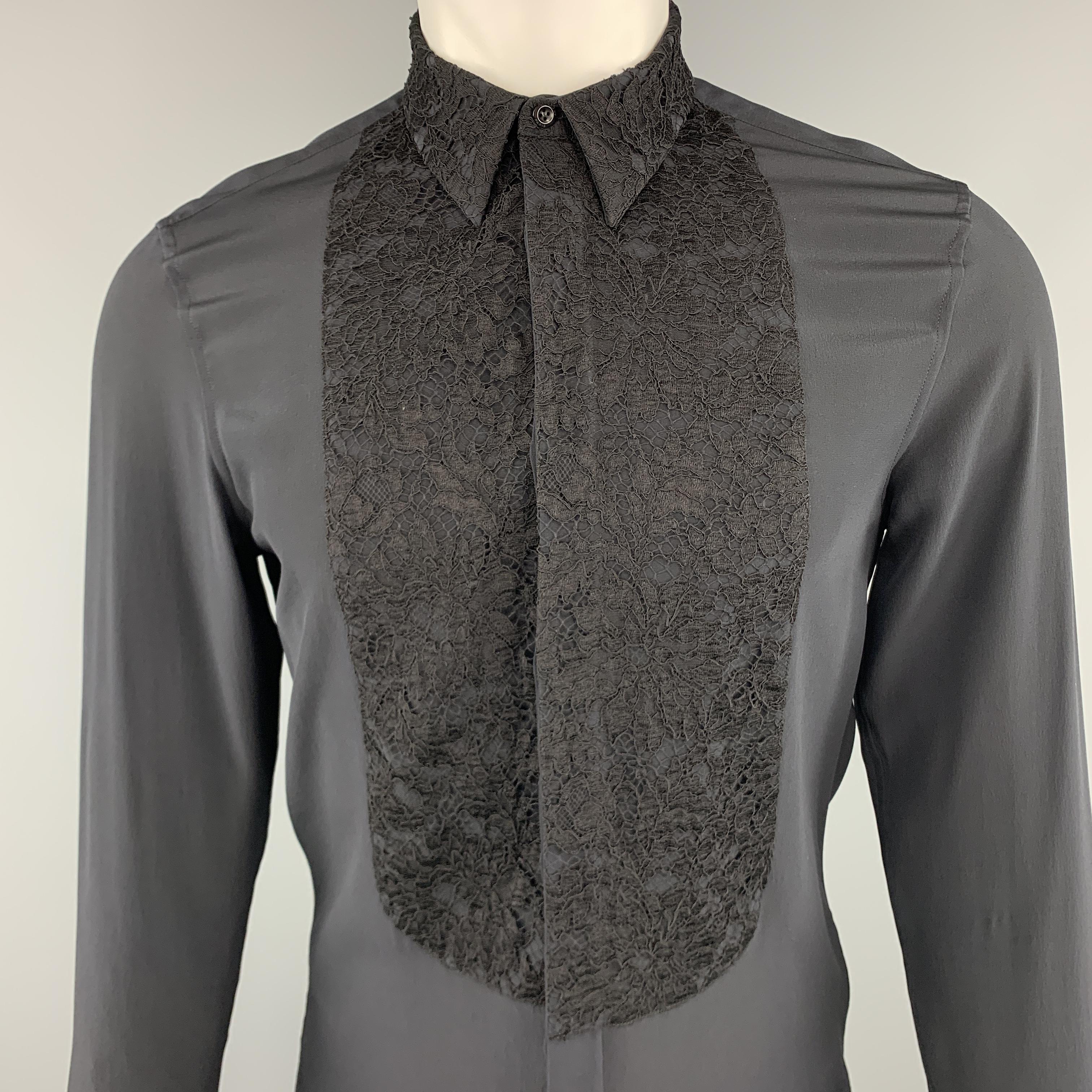 GIVENCHY by RICCARDO TISCI shirt comes in light weight black silk crepe with a hidden placket button up front, lace bib and cuff appliques, and T stitch back. Made in Italy.

Excellent Pre-Owned Condition.
Marked: 39

Measurements:

Shoulder: 16