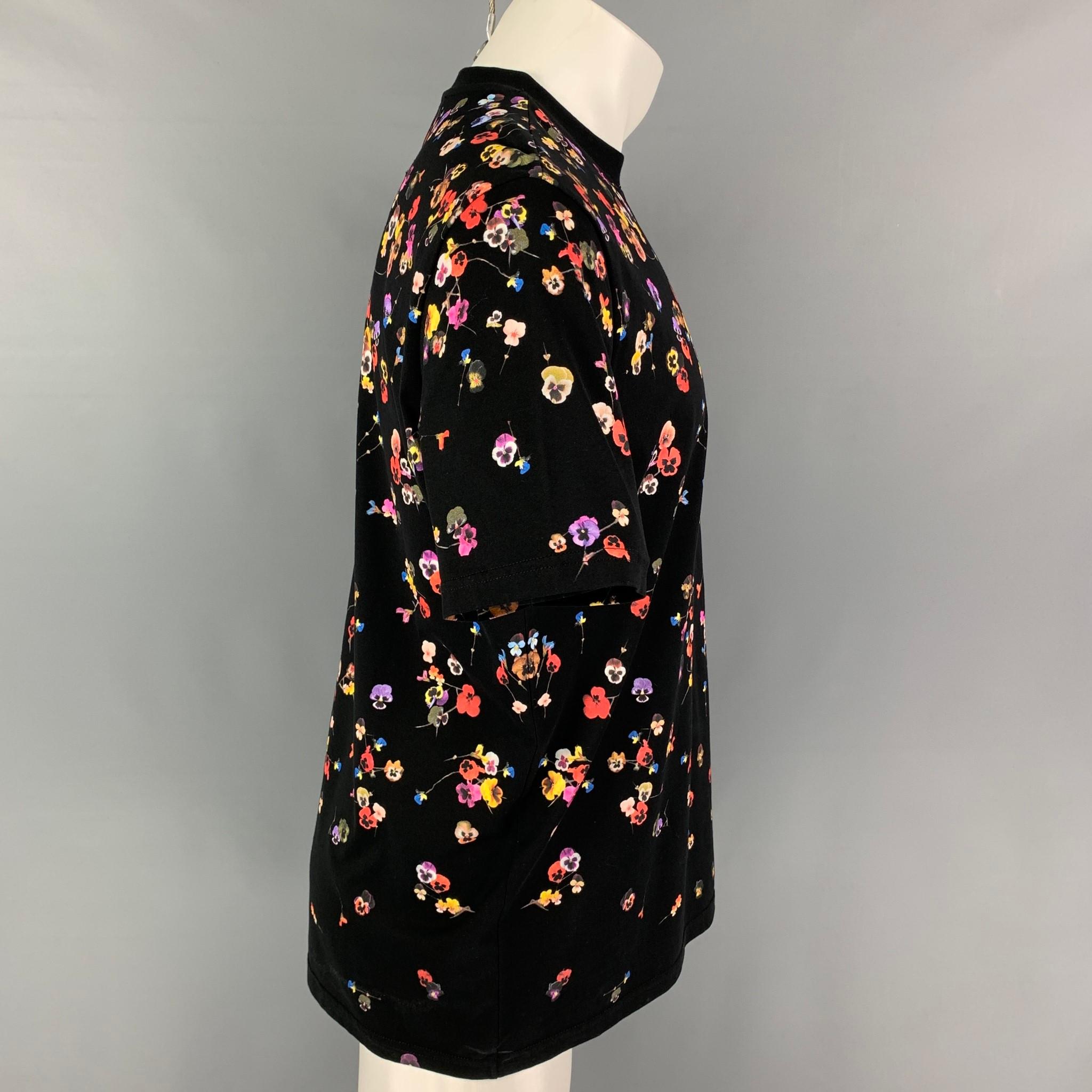 GIVENCHY t-shirt comes in a black cotton featuring a loose fit, multi-color floral print throughout, and a crew-neck. Made in Portugal. 

Excellent Pre-Owned Condition.
Marked: XS

Measurements:

Shoulder: 18.5 in.
Chest: 44 in.
Sleeve: 9.75