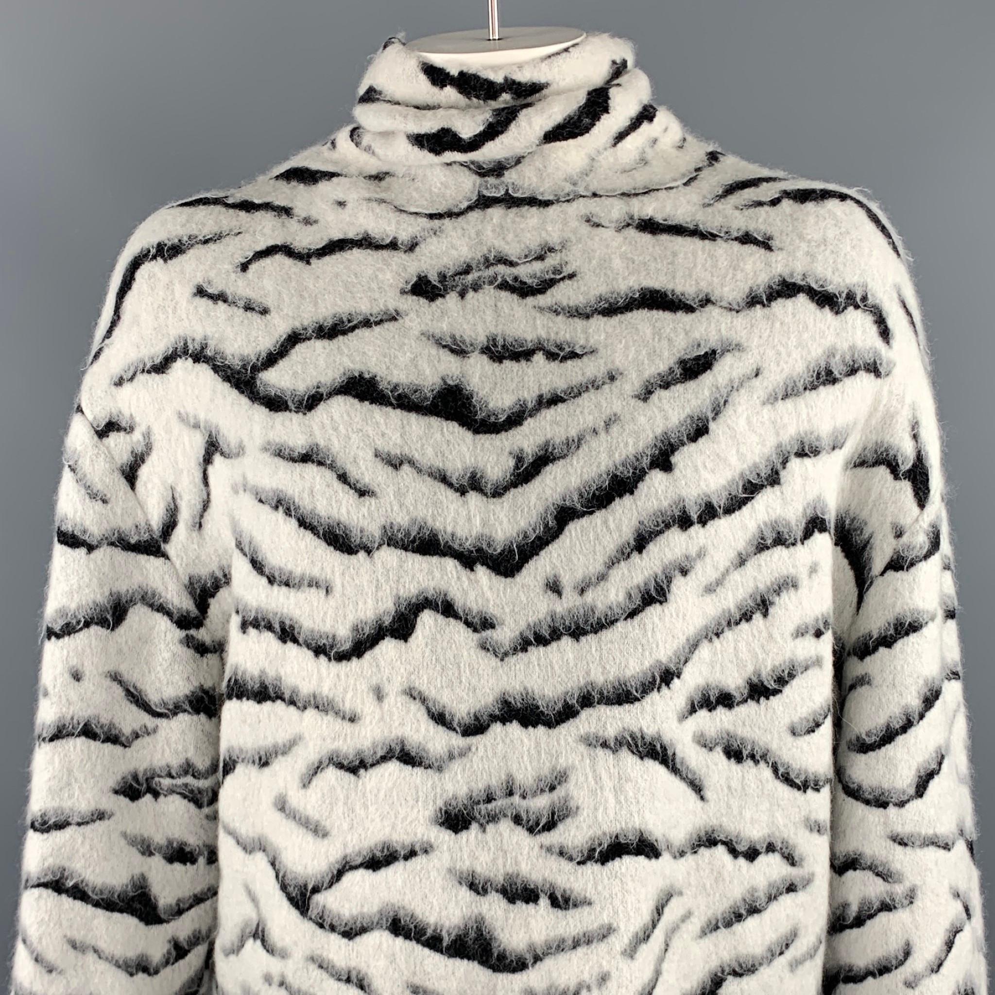 GIVENCHY sweater comes in a white & black tiger print mohair blend featuring a oversized turtleneck style and a back vent. Made in Italy.

Excellent Pre-Owned Condition.
Marked: XS

Measurements:

Shoulder: 20 in. 
Chest: 58 in. 
Sleeve: 22.5 in.
